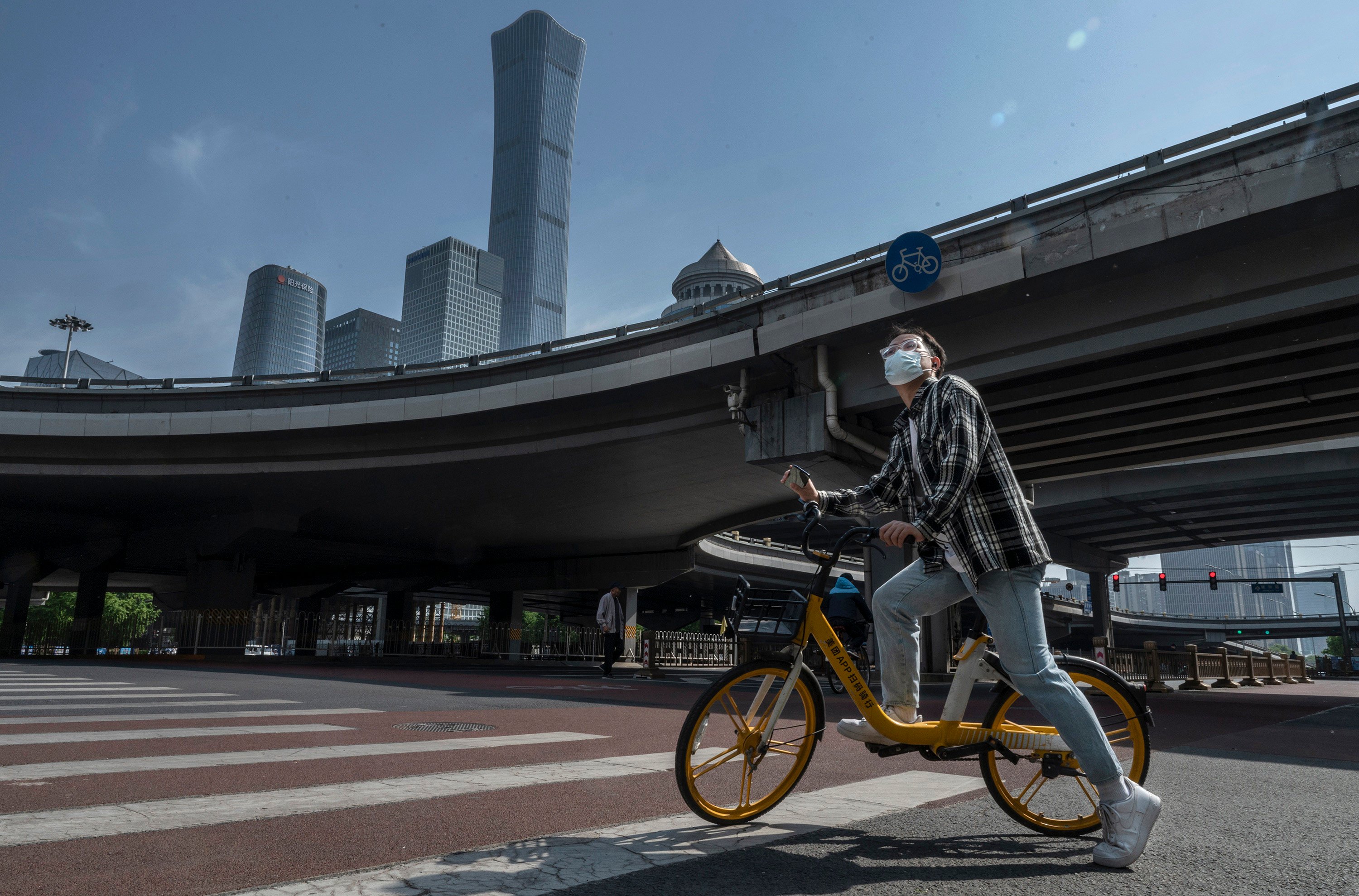 A cyclist stops at a quiet intersection in Beijing’s Central Business District, after the government recommended people work from home to prevent the spread of Covid-19, on May 5. Photo: Getty Images/TNS