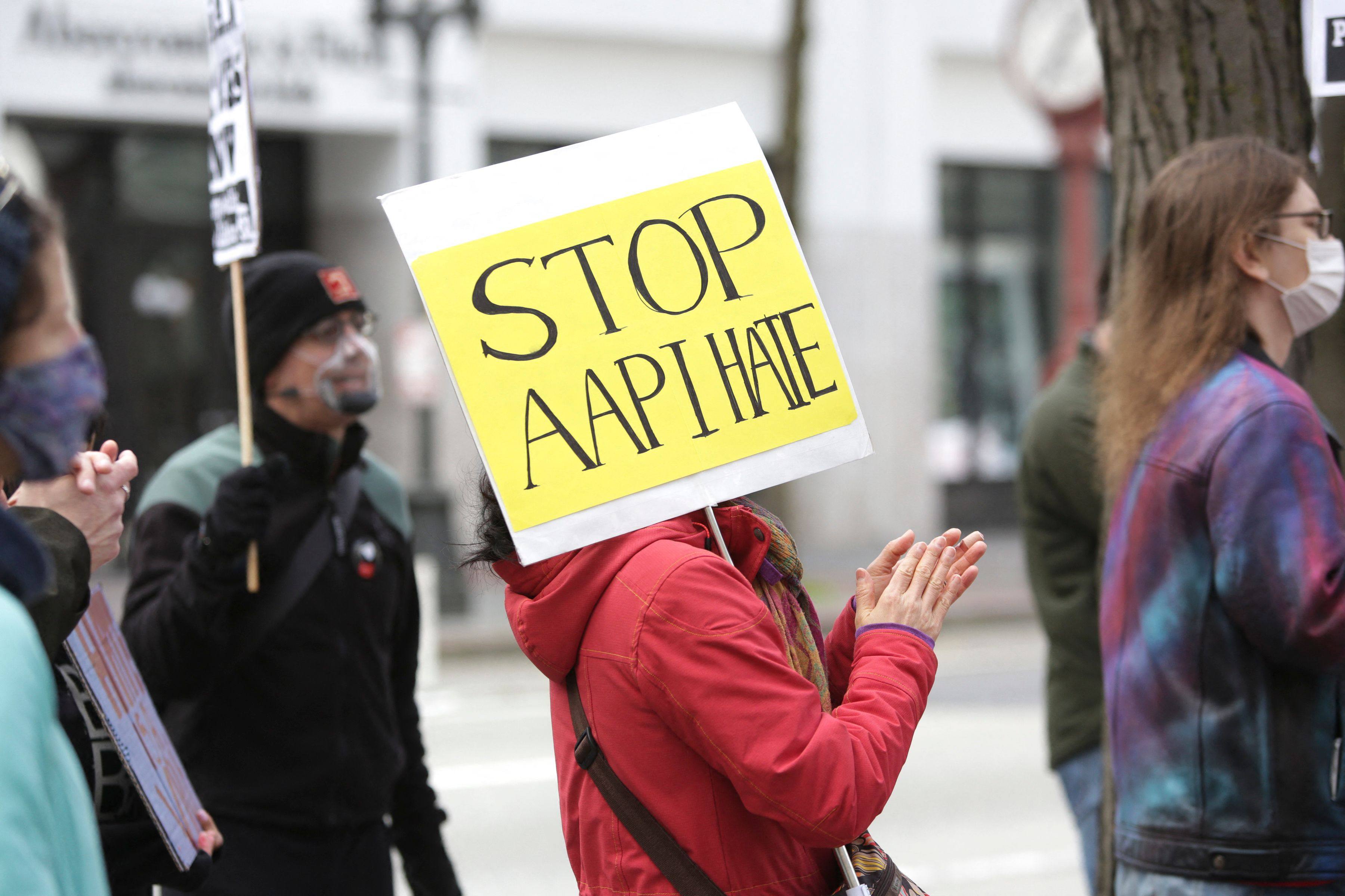 A demonstrator holds a sign calling for a end to hate against AAPI, or Asian-Americans and Pacific Islanders, in Seattle, Washington, in March 2021. Photo: AFP