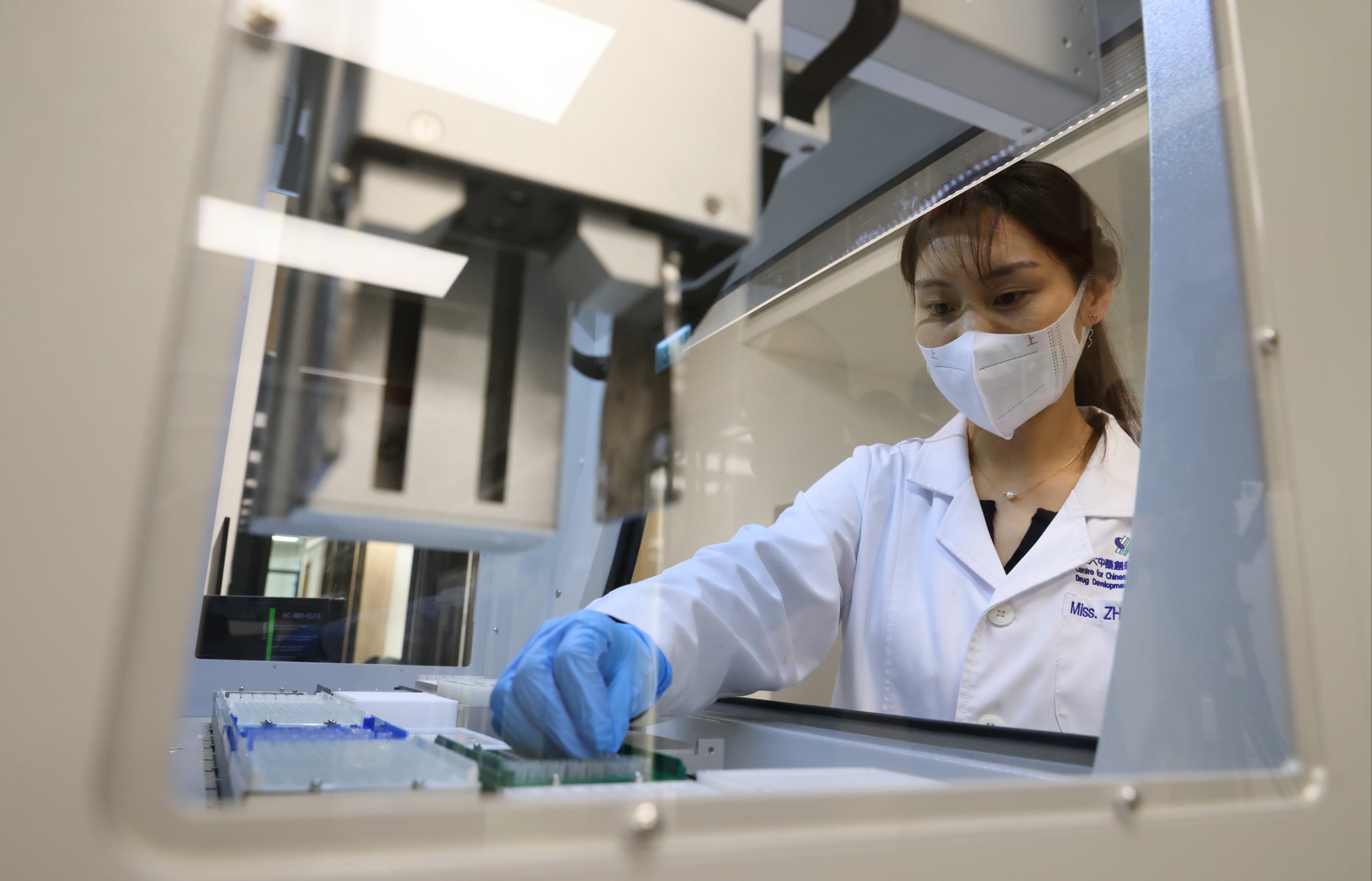 A researcher uses automated equipment for high-throughput screening, a process which allows for the mass testing of chemicals, at the Centre for Chinese Herbal Medicine Drug Development, at Hong Kong Science Park, on December 22, 2021. Photo: Dickson Lee