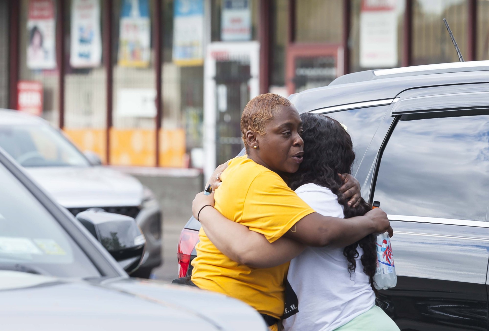 Two community members hug near the shooting scene in Buffalo. Photo: EPA-EFE