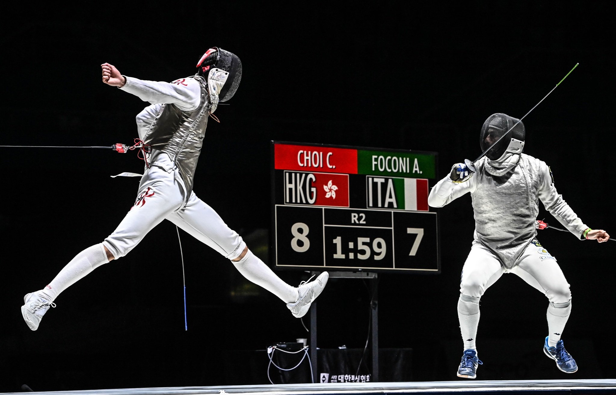 Ryan Choi (left) leaps during his semi-final against former world No 1 Alessio Foconi. Photo: FIE