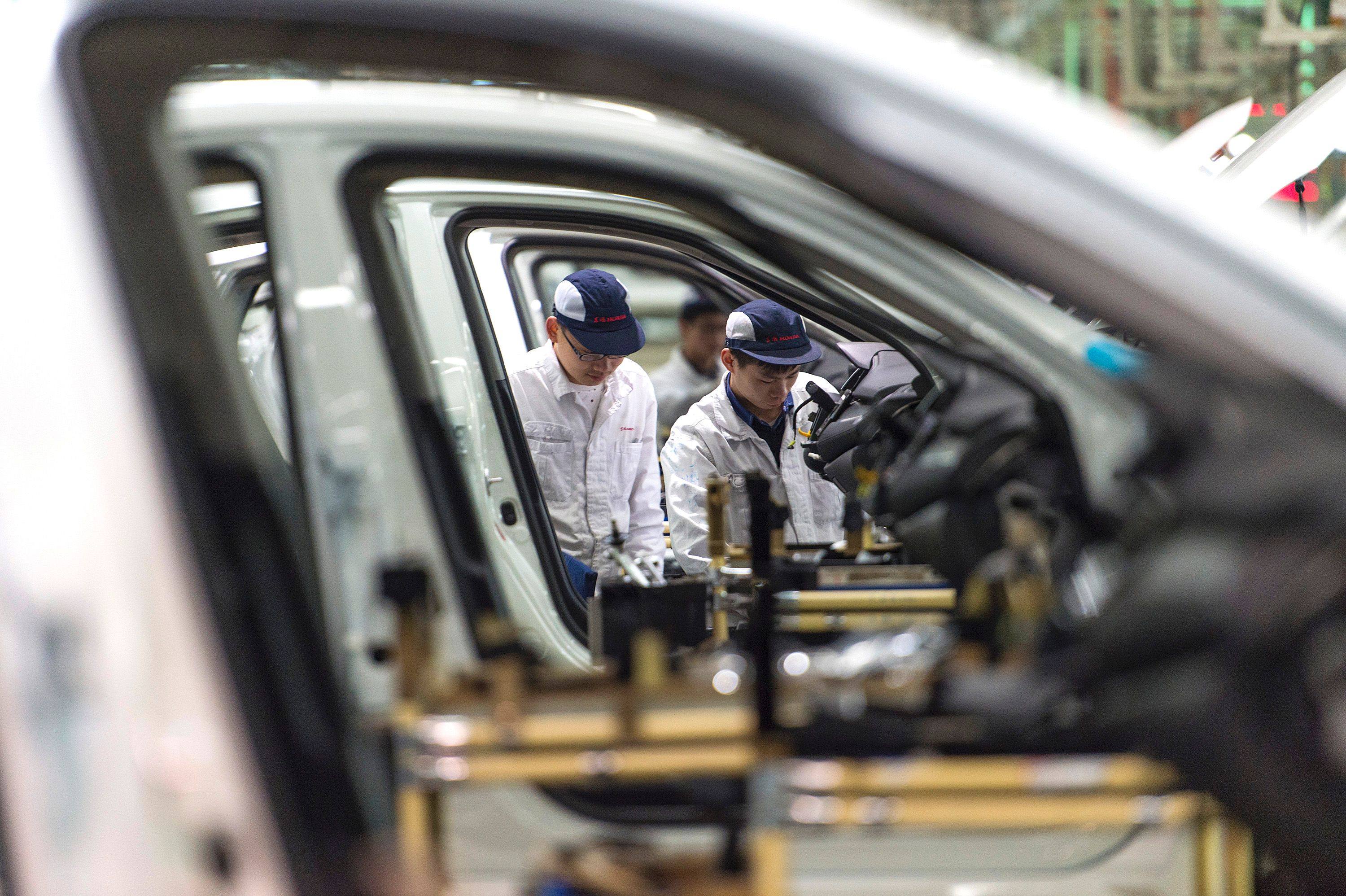 Employees work on the Honda Civic production line at a factory in Wuhan that the Japanese carmaker operates as a joint venture with Dongfeng Motor Group. Photo: AFP