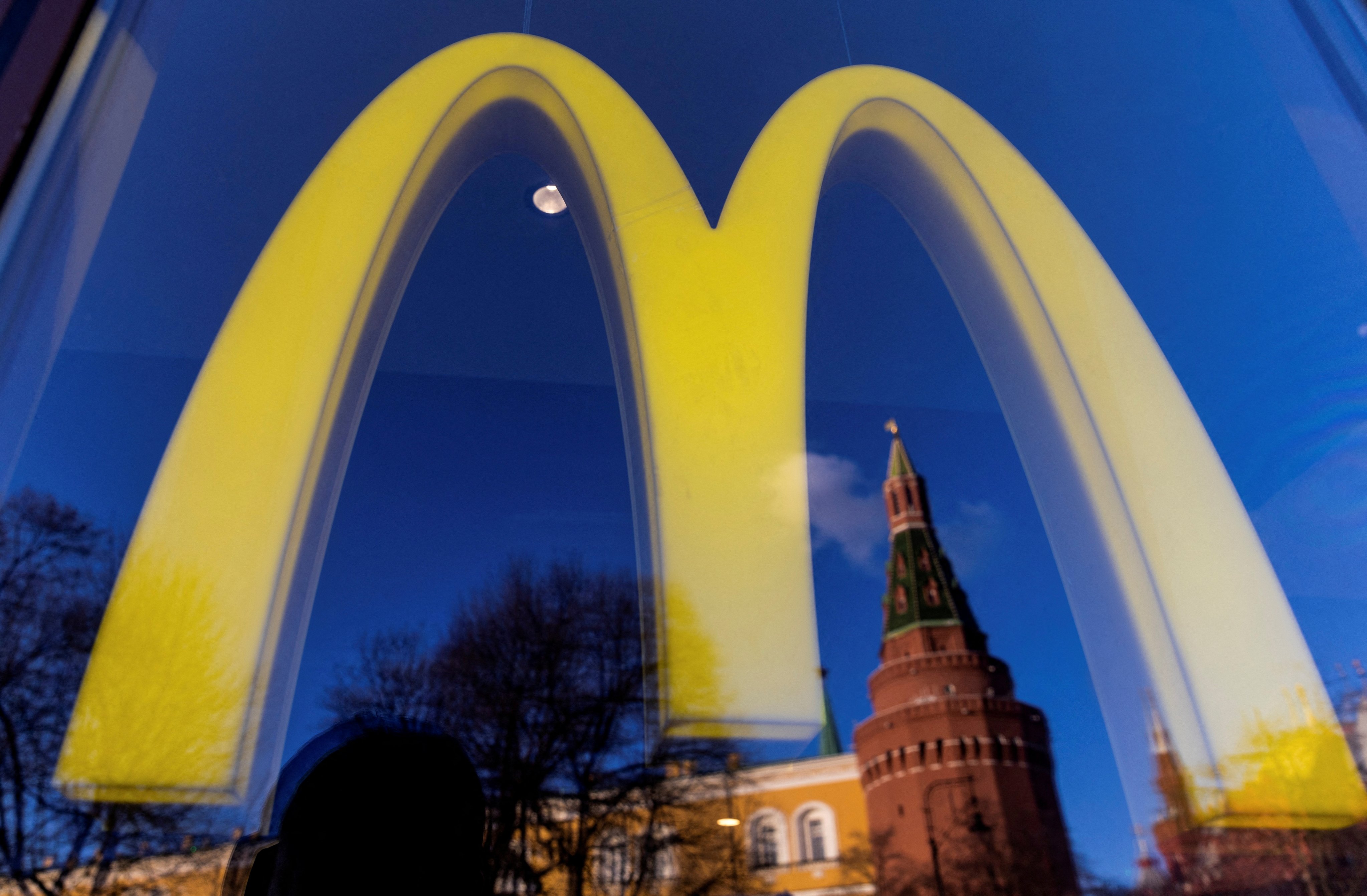 A logo of the McDonald’s restaurant and the Kremlin’s tower seen through a window. Photo: Reuters