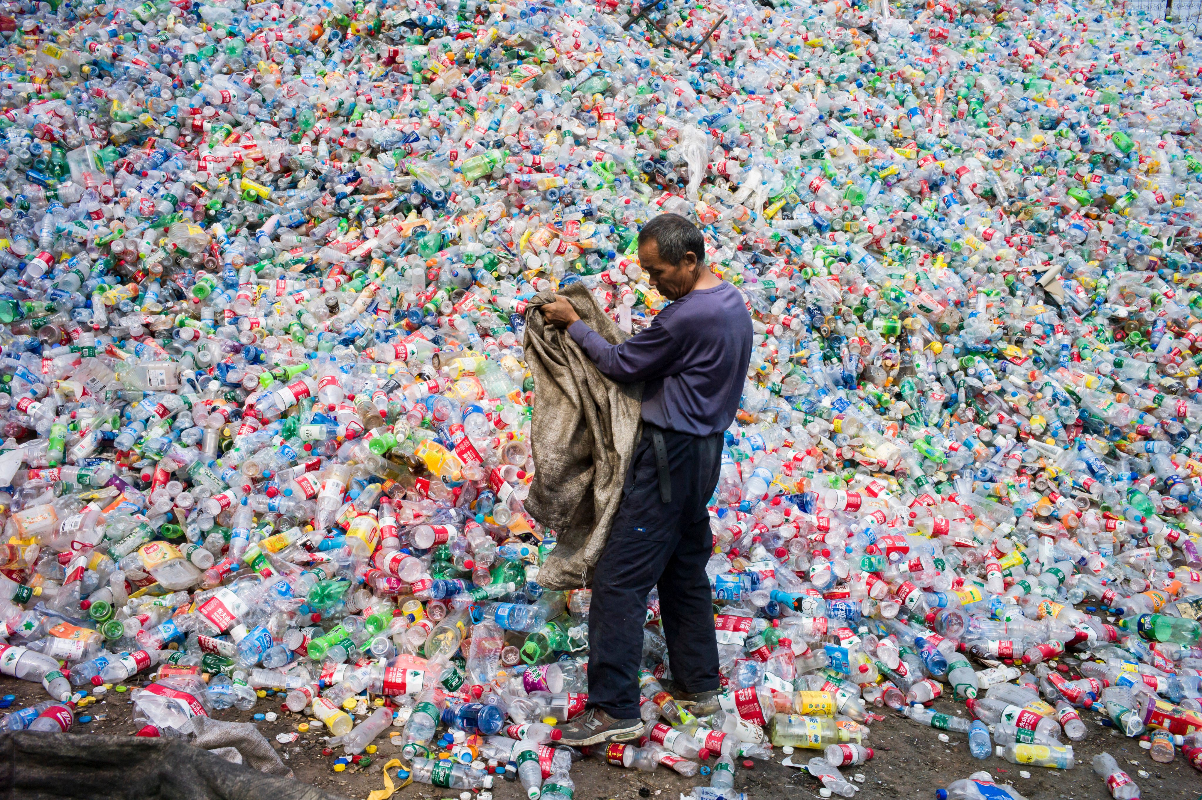 A Chinese worker sorts through a tidal wave of plastic at a waste management company in 2015. Photo: AFP