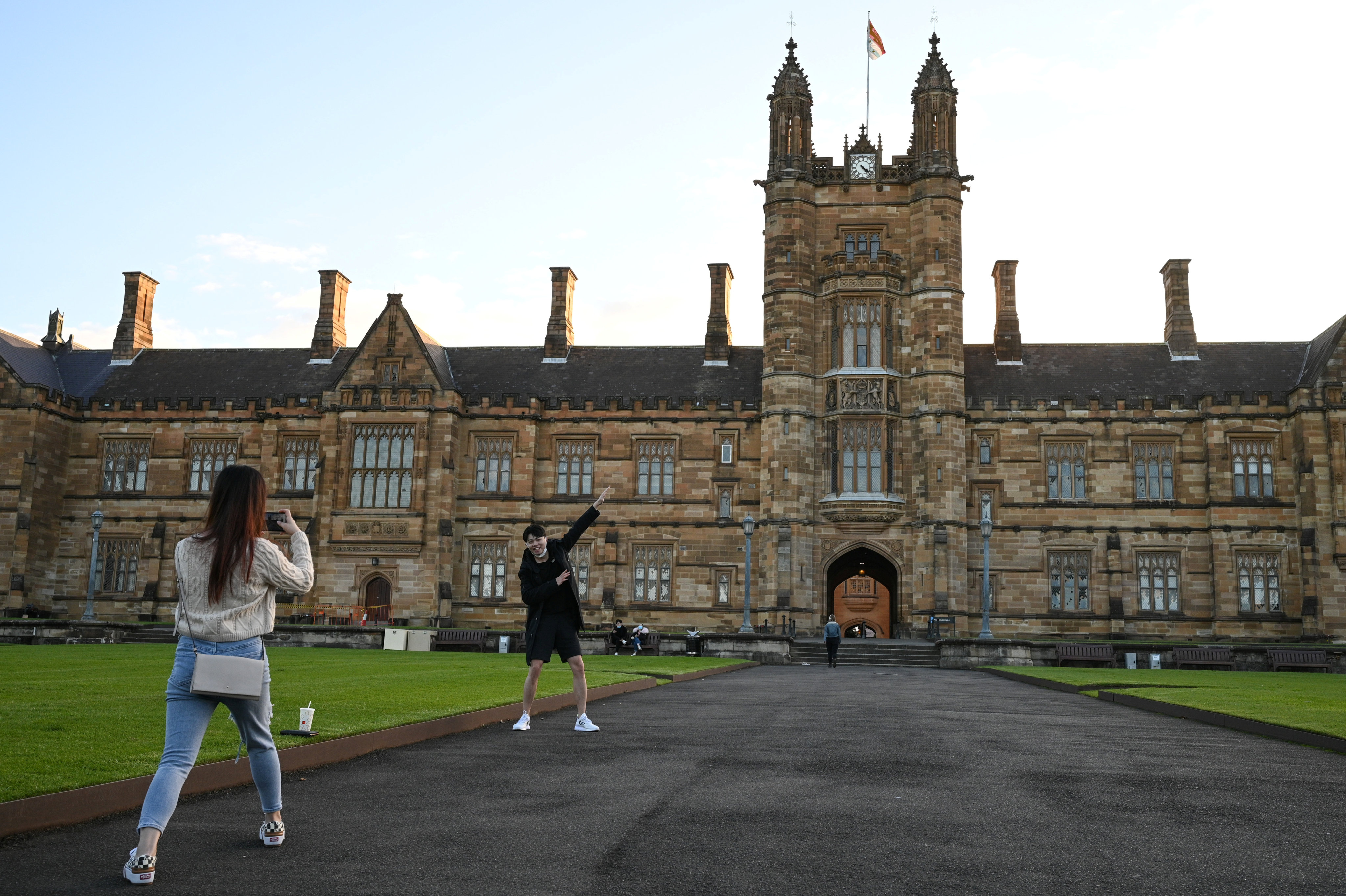 Chinese students at the University of Sydney take photos on the campus on August 20, 2020.  Photo: Reuters