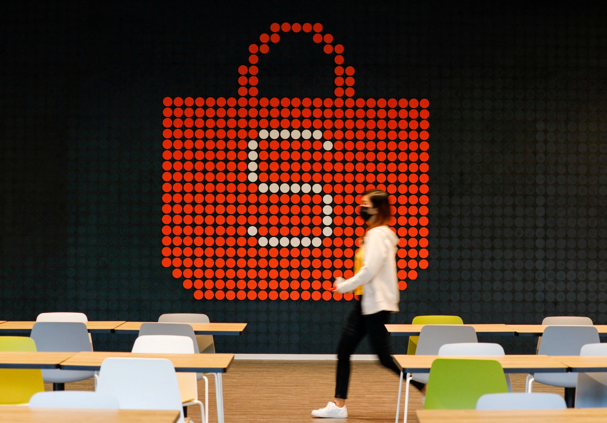A person walks in front of a sign for Shopee, the e-commerce arm of Sea Ltd, at its office in Singapore. Photo: Reuters