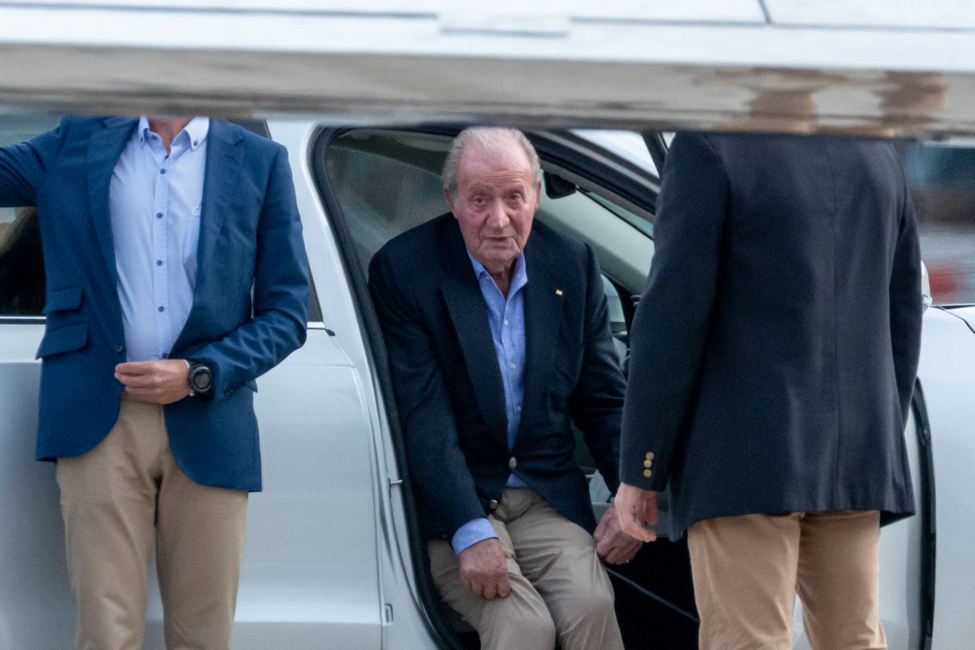 Spain’s former King Juan Carlos sits in a car after arriving by a private jet in Vigo, Pontevedra on Thursday. Photo: AFP