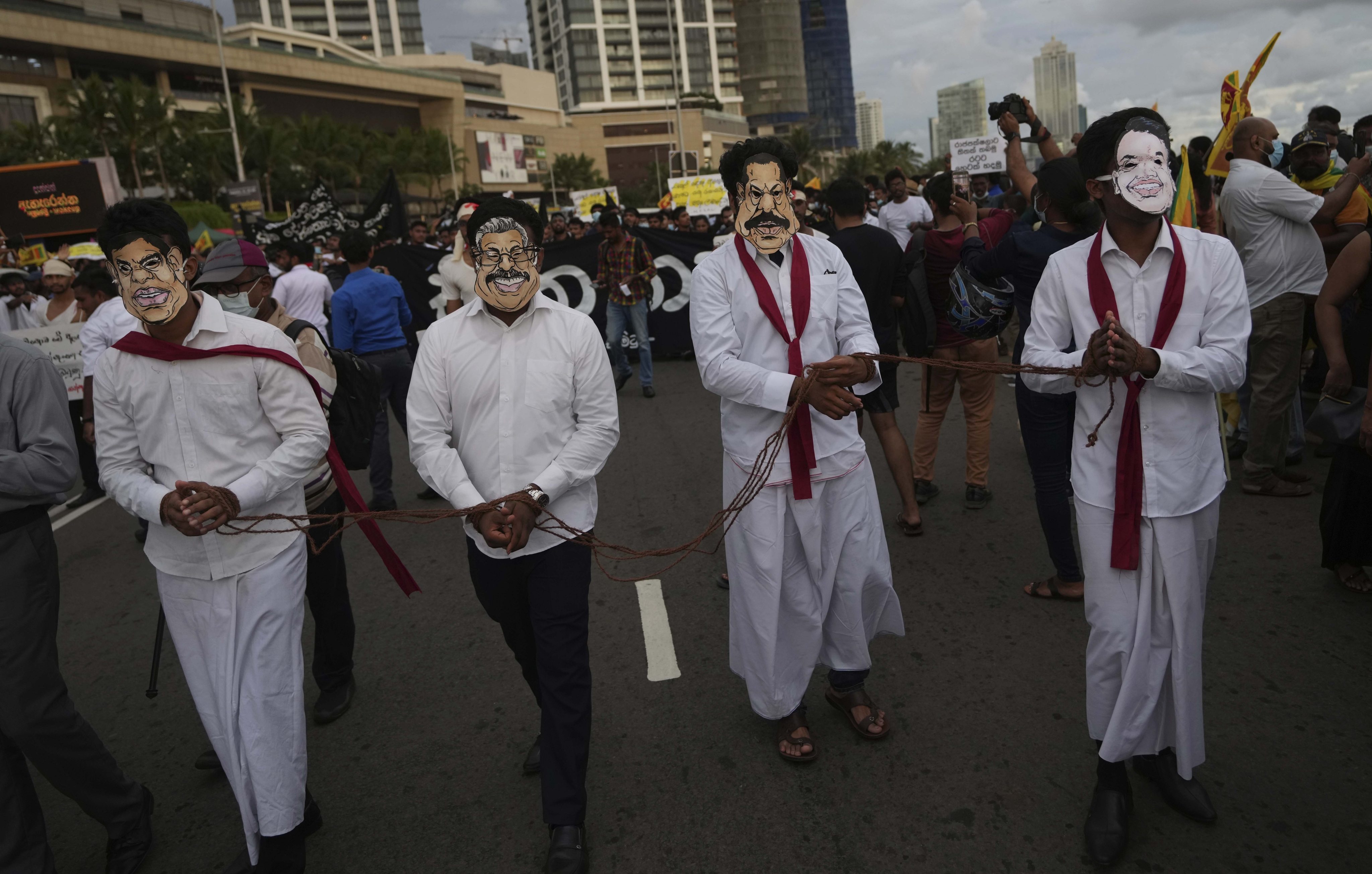 Sri Lankan protesters wear masks of president Gotabaya Rajapaksa’s family members during a march demanding Gotabaya resign. File photo: AP