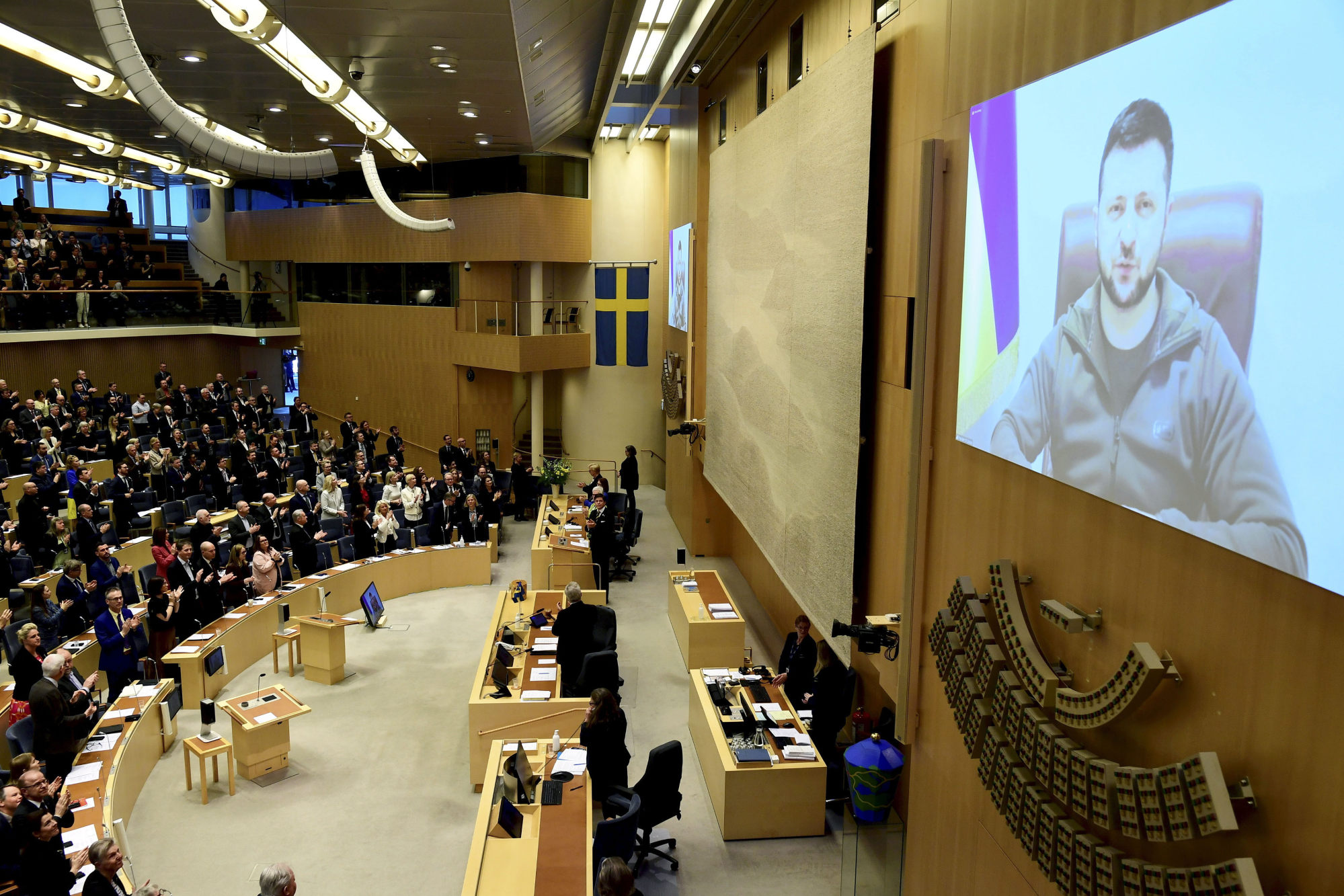 Volodymyr Zelensky receives a standing ovation as he addresses Swedens parliament via video link. Photo: AP