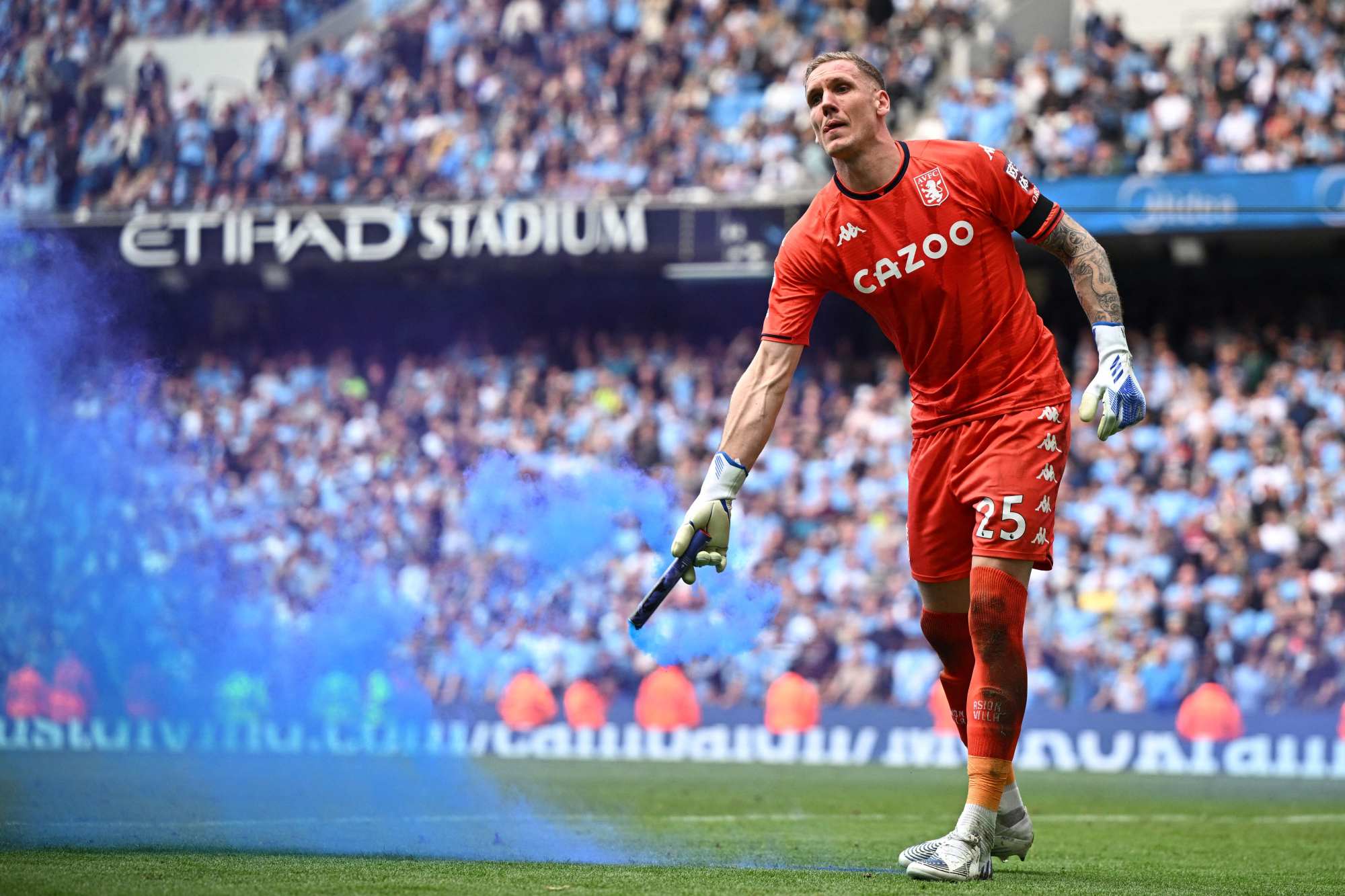 Aston Villa’s Swedish goalkeeper Robin Olsen removes a smoke bomb during the English Premier League football match between Manchester City and Aston Villa at the Etihad Stadium in Manchester, England, on Sunday. Photo: AFP