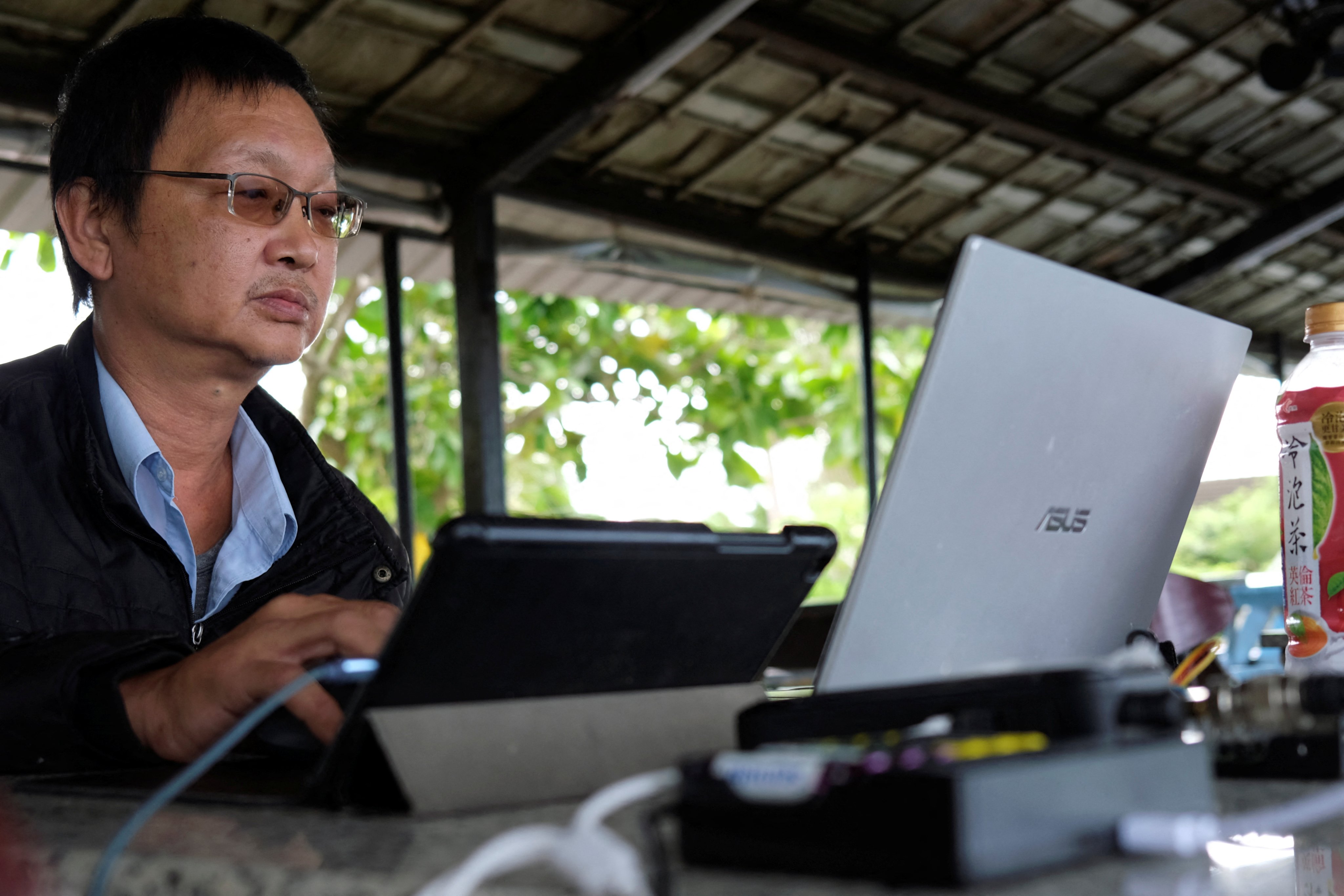 Radio enthusiast Robin Hsu, 50, monitors flight traffic in air space southwest of Taiwan, from a cafe in Pingtung, Taiwan on May 3, 2022. He says: “The Chinese Communist planes are like flies on your dining table. If you kill them on your plate then your meal is ruined. All you can do is to wave them away.” Photo: Reuters