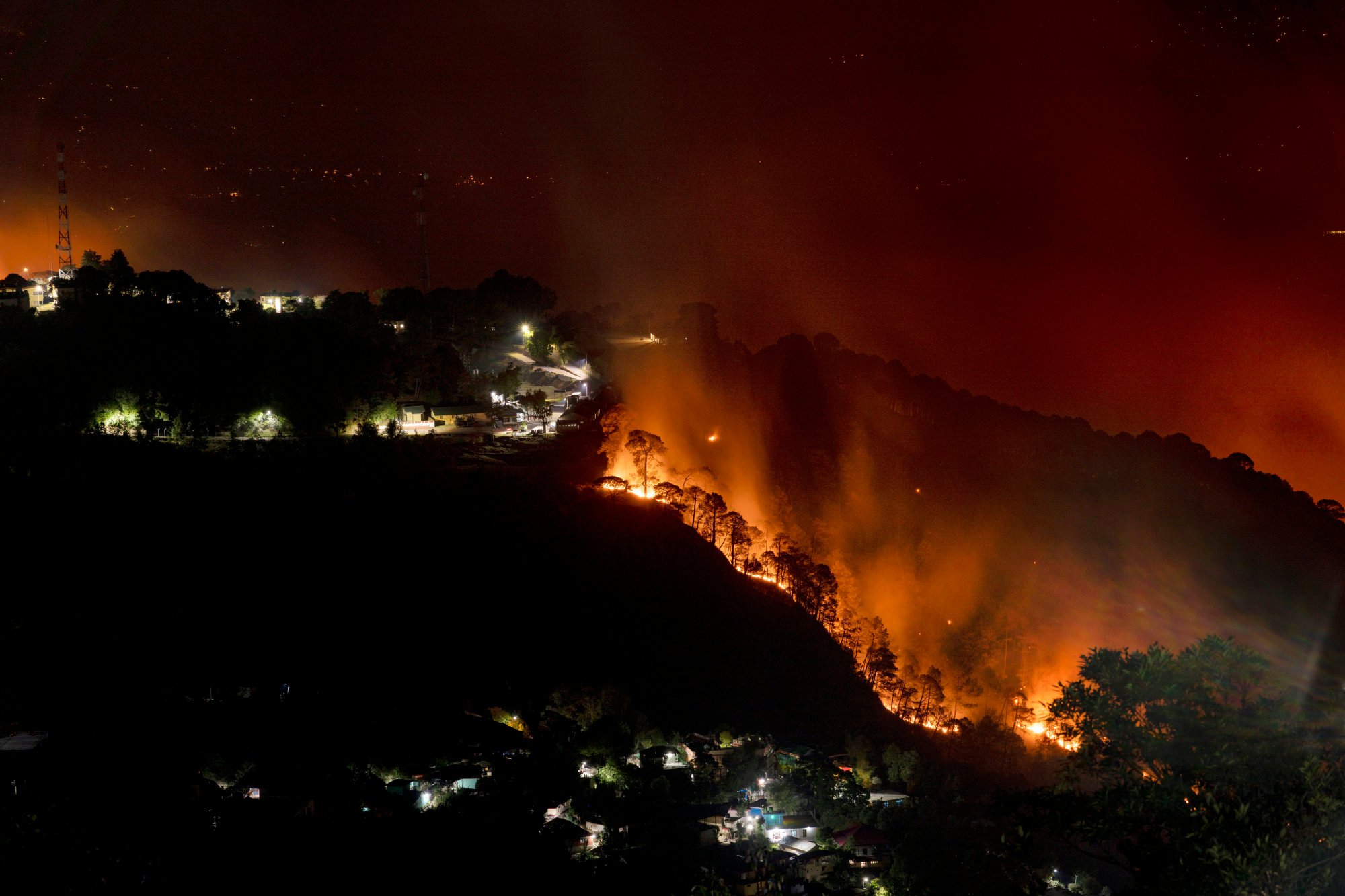 A forest on a mountain slope in Dharamsala, India, burst into flames in April amid the heatwave. Photo: AP