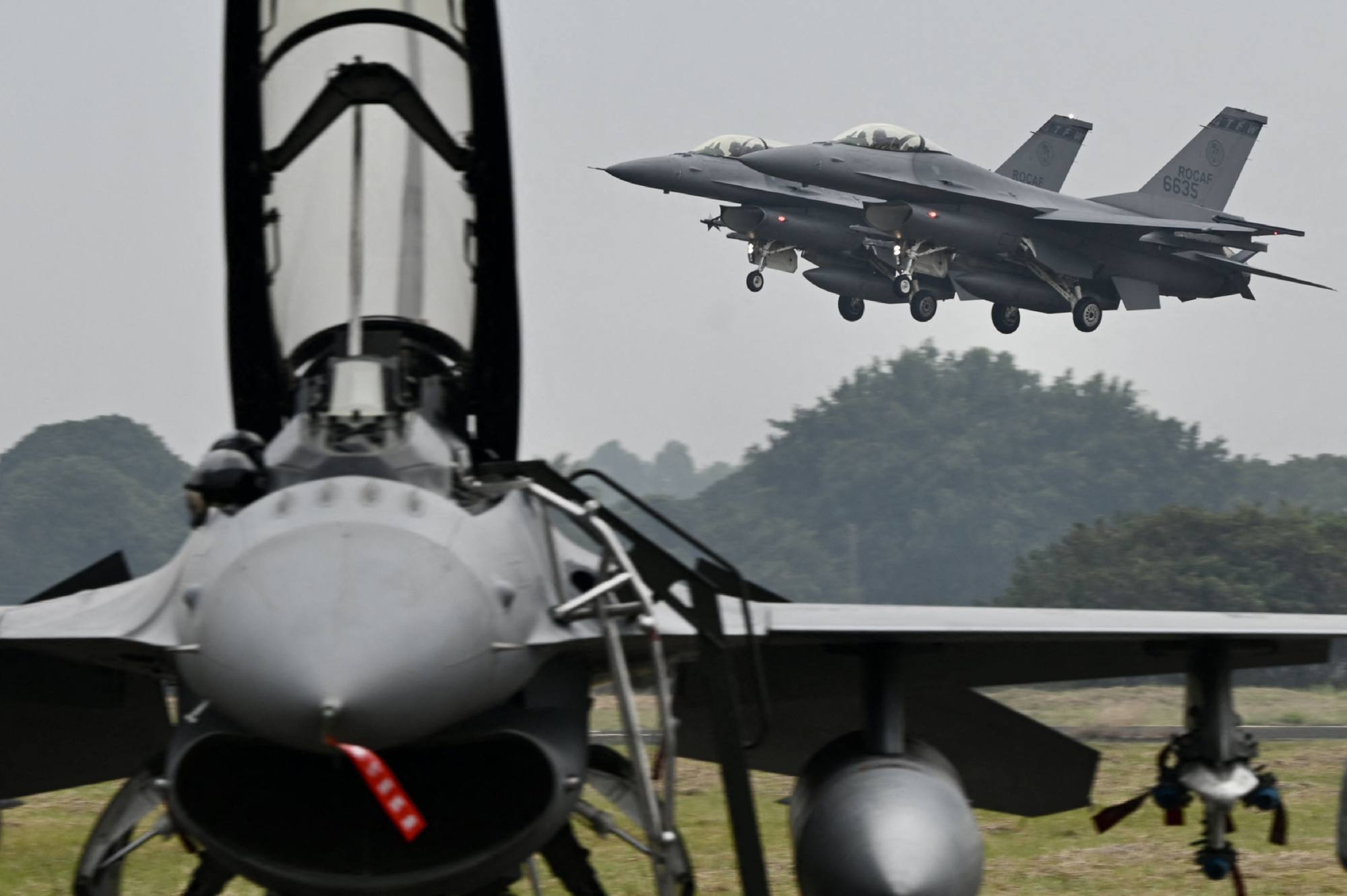 Two armed US-made F-16V fighters fly over at an air force base in Chiayi, southern Taiwan, in January. Photo: AFP