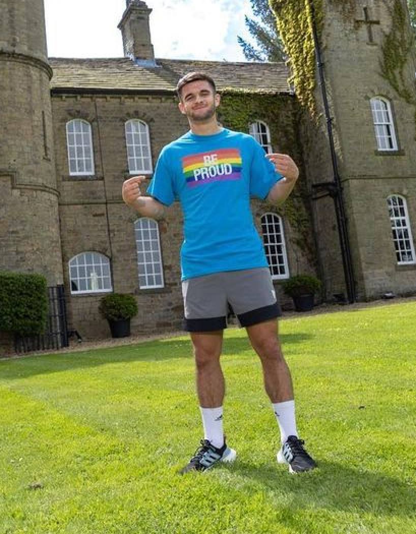 Jake Daniels poses in a Be Proud T-shirt on Instagram after coming out as gay. Photo: @officialjakedaniels/Instagram