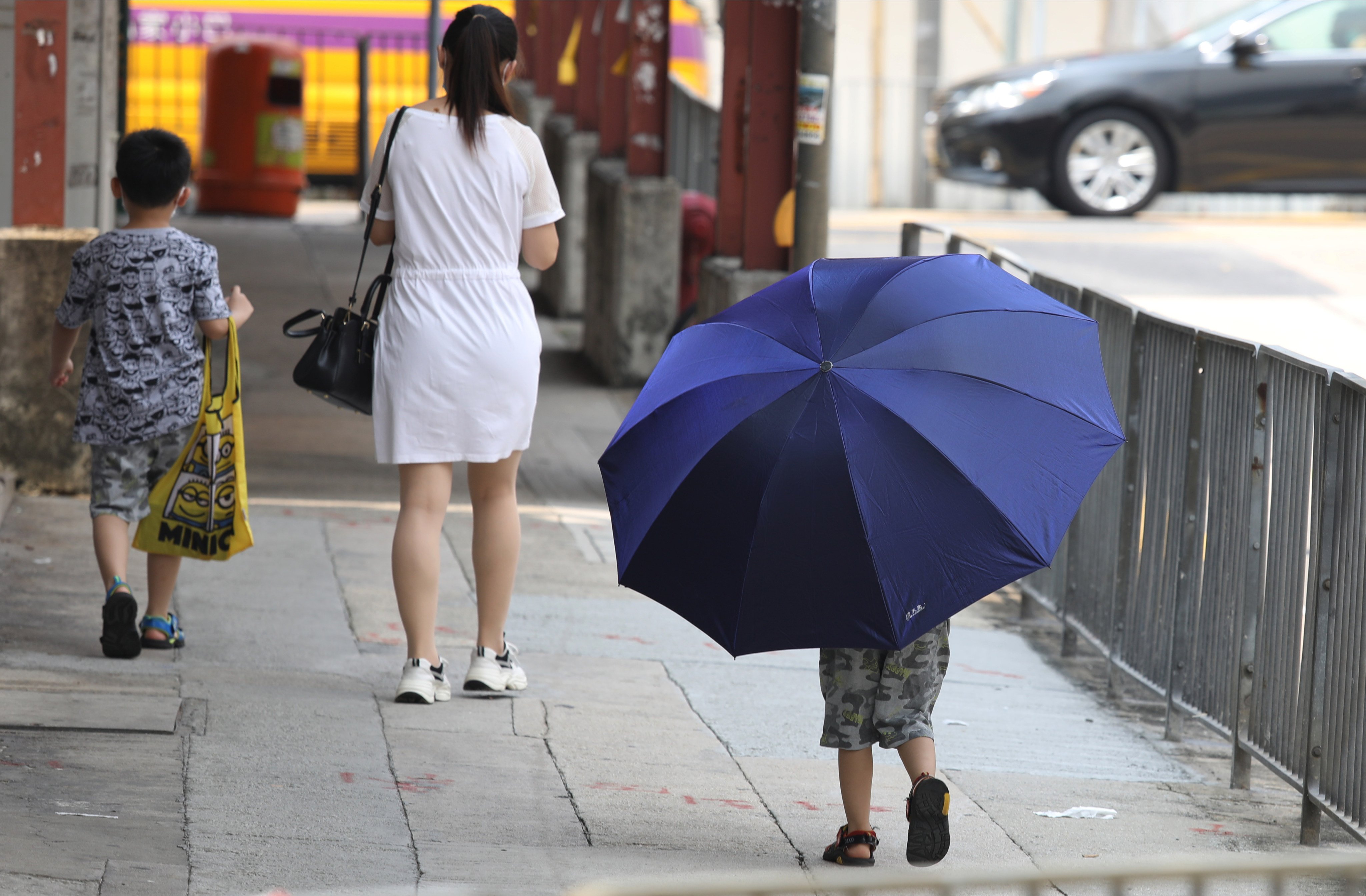 A child carries a large umbrella in Kowloon City, in September 2020. Children will not be properly respected until, like adults, they fully enjoy the protections of the criminal law. Photo: Nora Tam