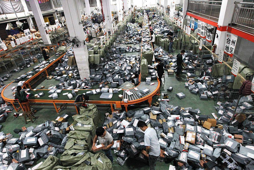 Express delivery staff deal with a mass of parcels in a warehouse in Wenzhou. The impossibility of making a decent living without an adequate education is a common theme in author Dan K. Woo’s short stories about life in modern China. Photo: Getty Images