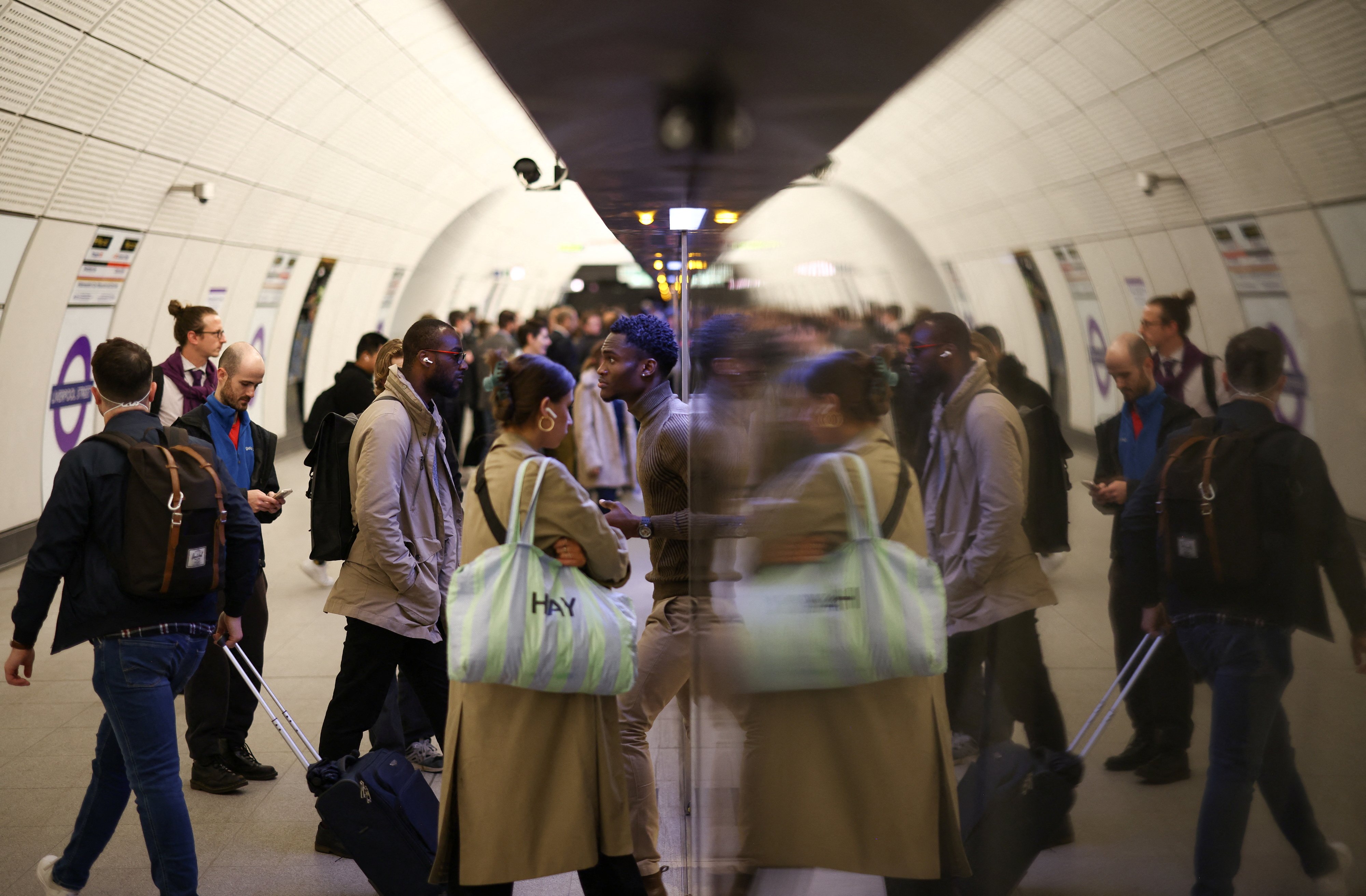 Passengers board an Elizabeth Line train at Liverpool Street underground station. Photo: Reuters