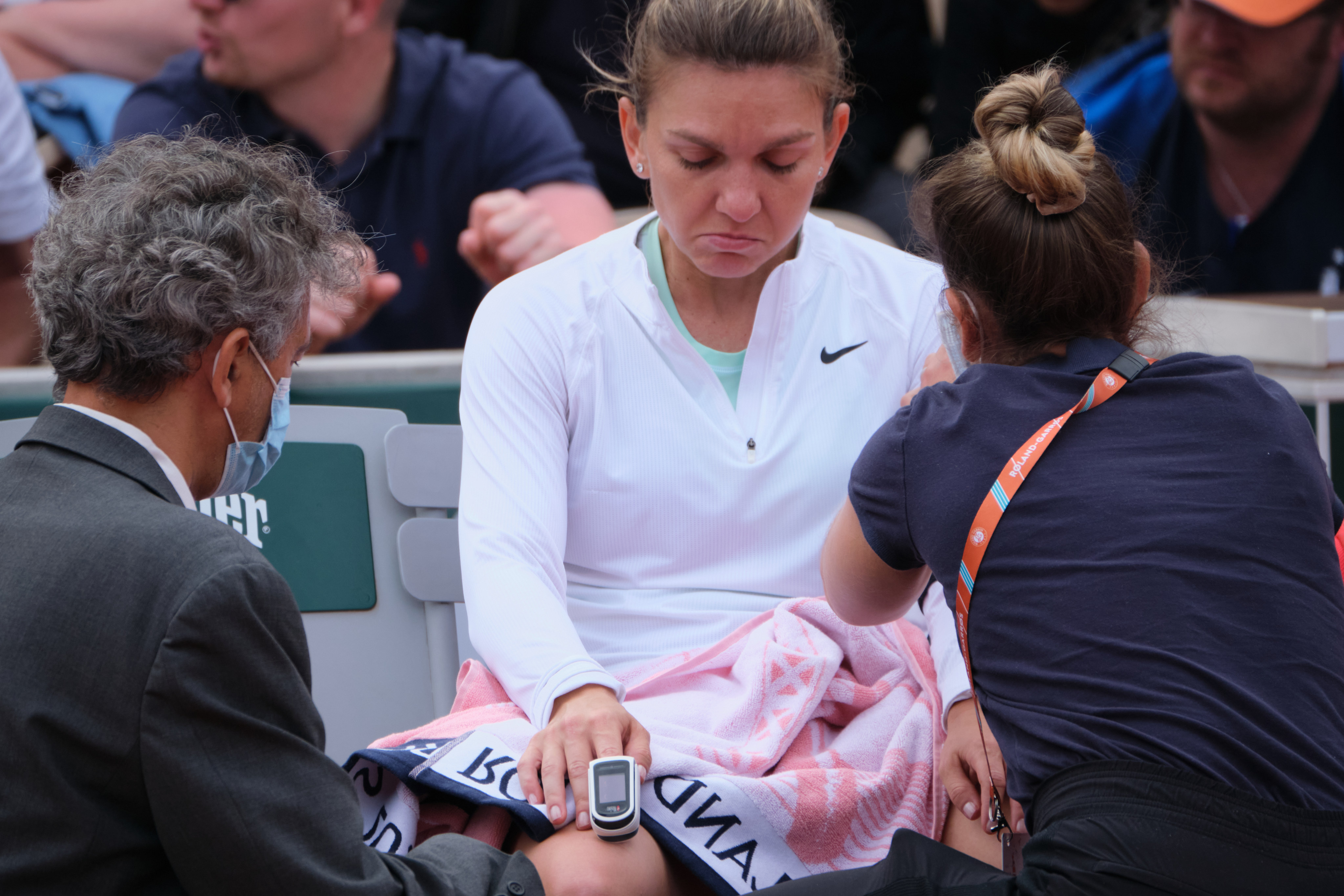 Simona Halep receives medical help during her second round match against Zheng Qinwen. Photo: Xinhua