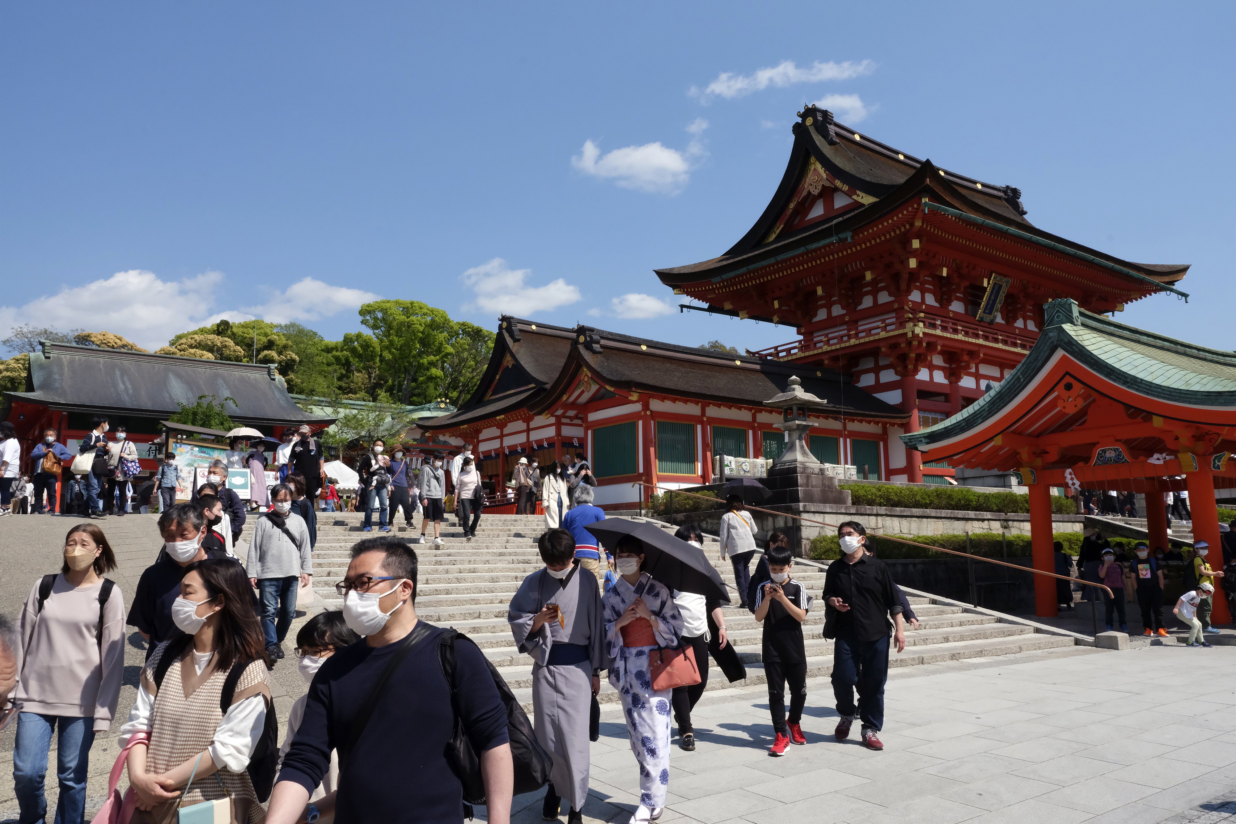 Tourists at an entrance of Fushimi Inari shrine in Kyoto, Japan. Photo: Bloomberg