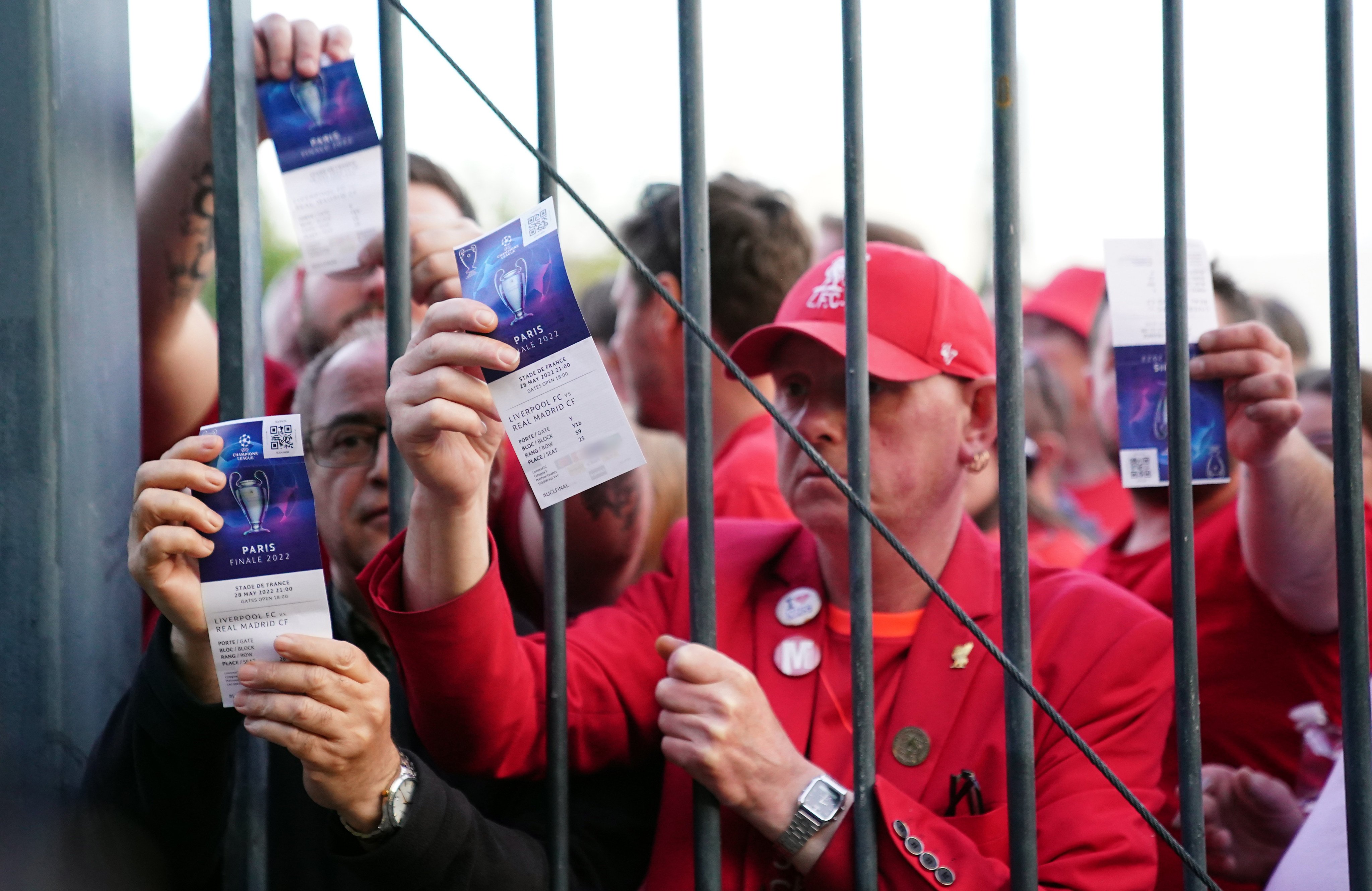 Liverpool fans stuck outside the ground as they show their match tickets before the Uefa Champions League final between Liverpool and Real Madrid at the Stade de France in Paris on May 28. Photo: PA Wire / DPA