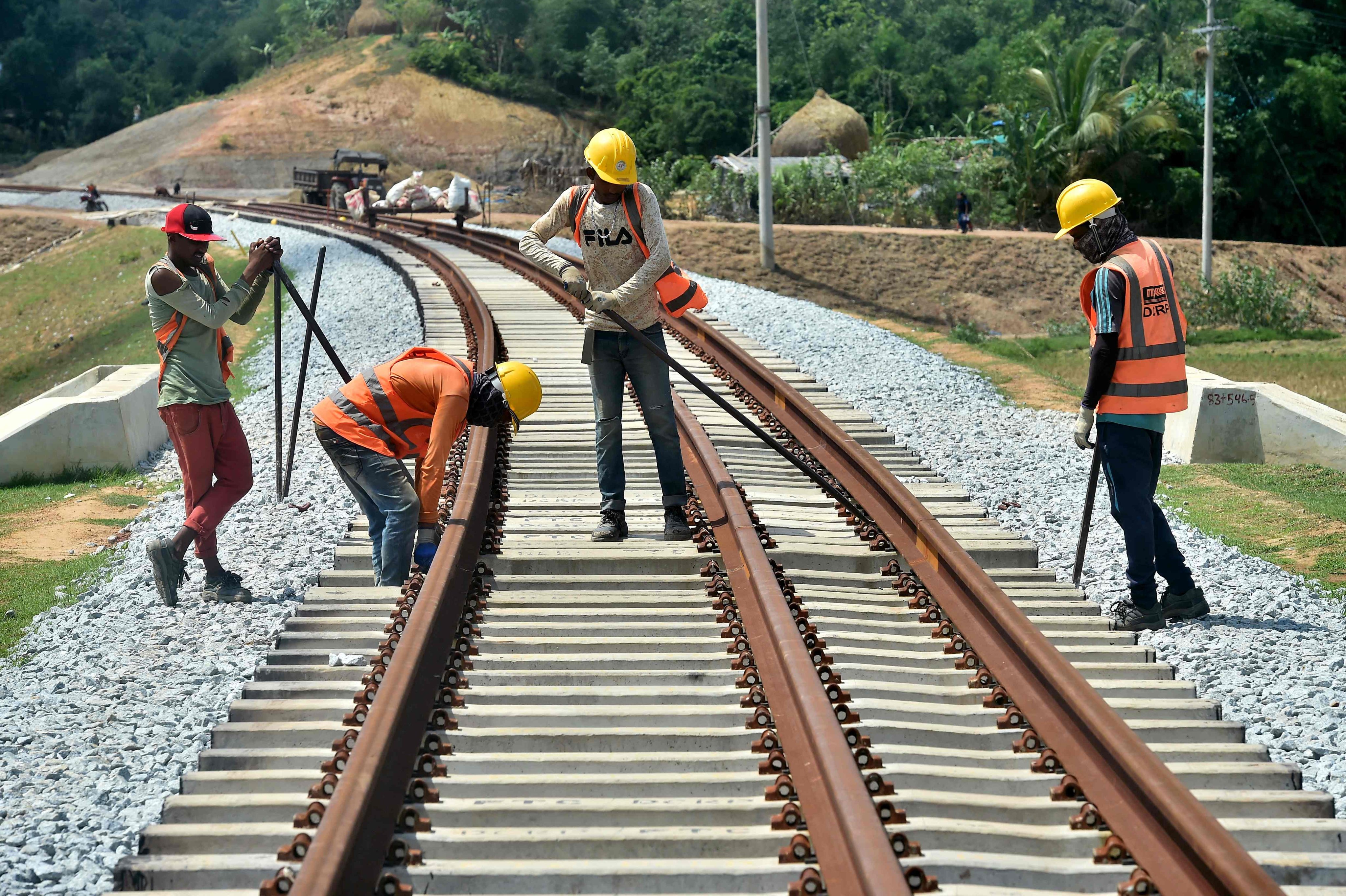 Workers adjusts fasteners during construction of the Chittagong-Cox’s Bazar railway line in Ramu, Bangladesh, on May 17. Photo: AFP