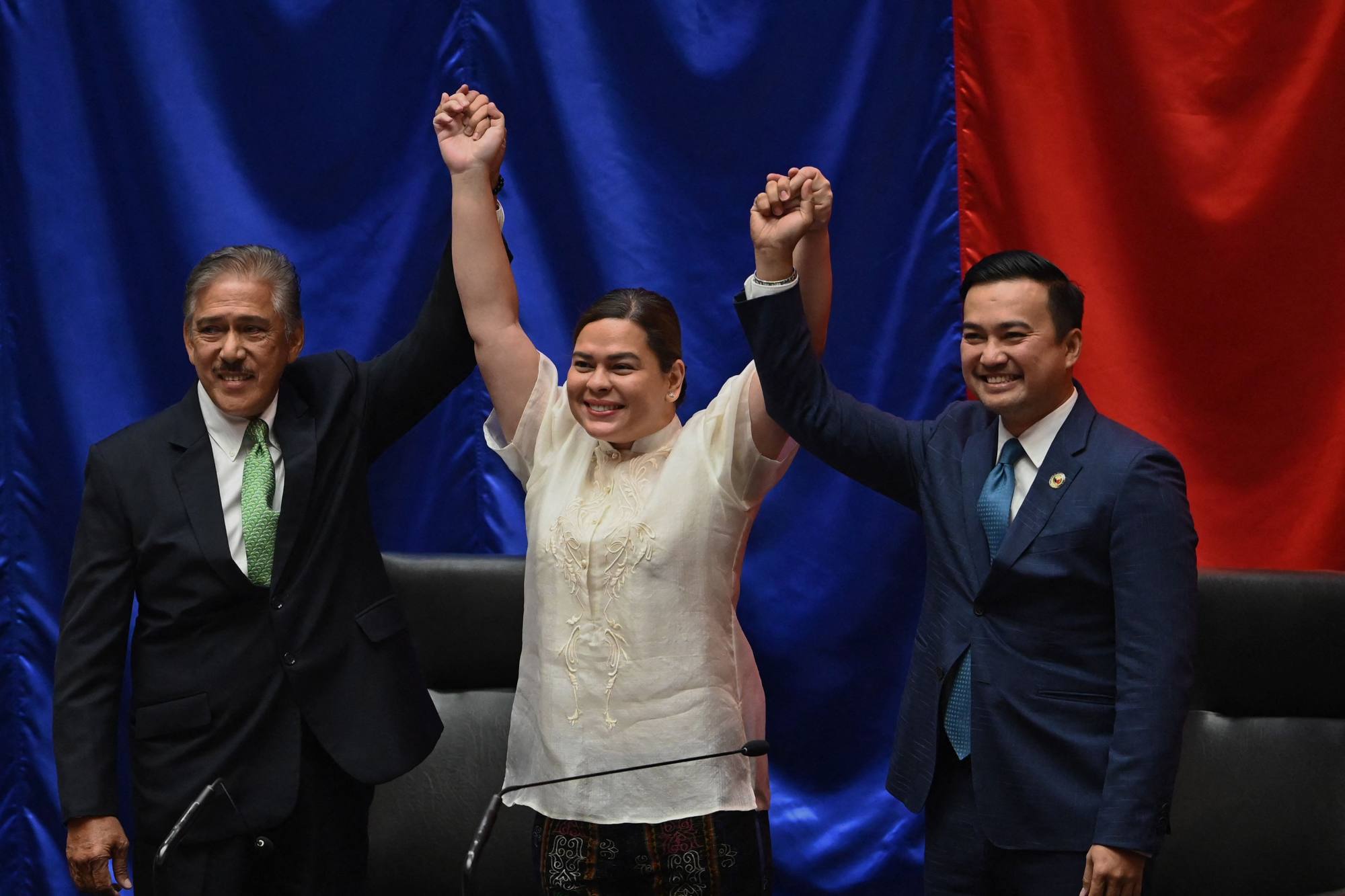 Sara Duterte (C), daughter of outgoing President Rodrigo Duterte, is proclaimed winner of the vice presidential race by Senate President Vicente Sotto (L) and House Speaker Lord Allan Velasco at the House of Representatives on Wednesday. Photo: AFP