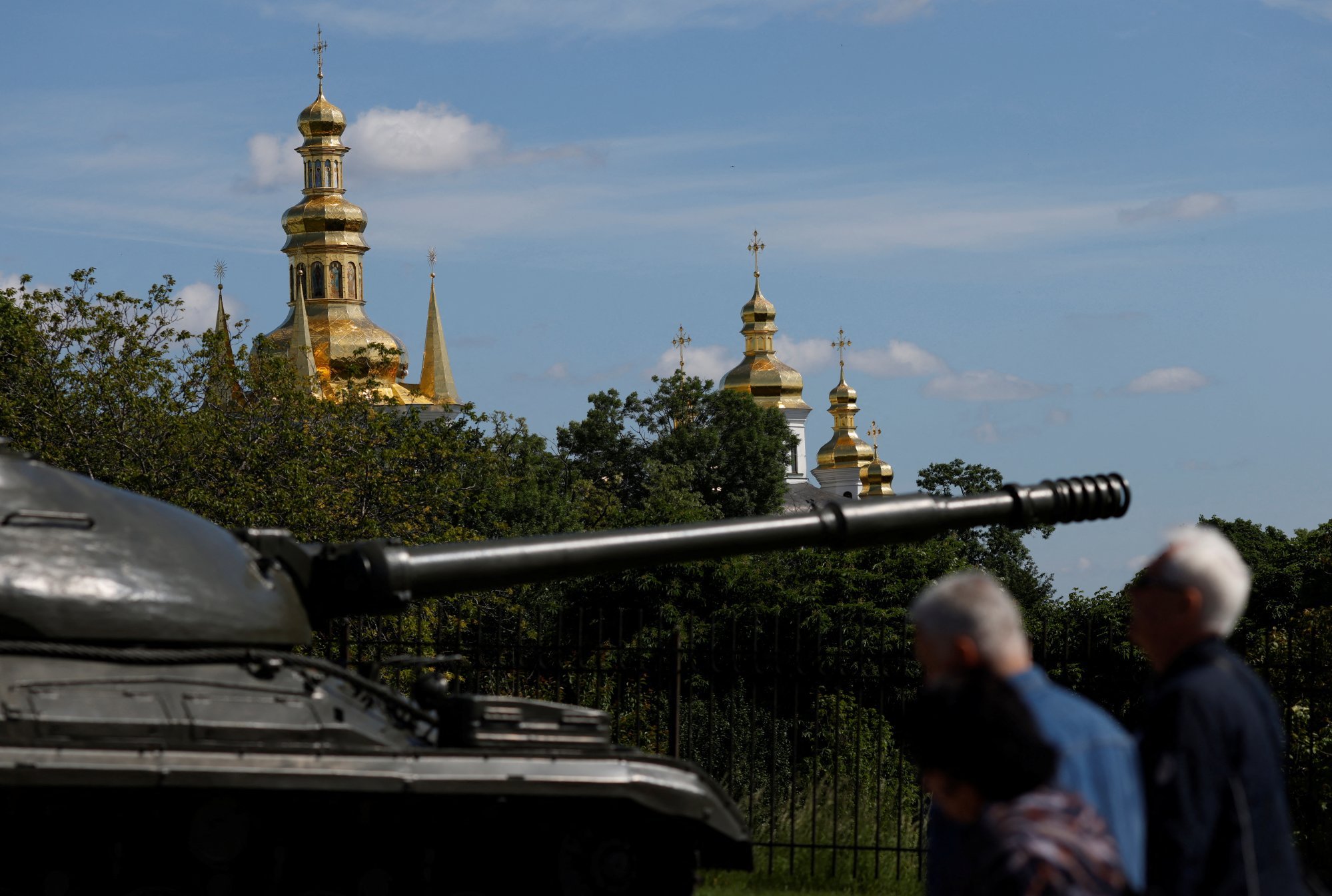 People pass a tank on display outside a monastery in Kyiv on Sunday. Photo: Reuters