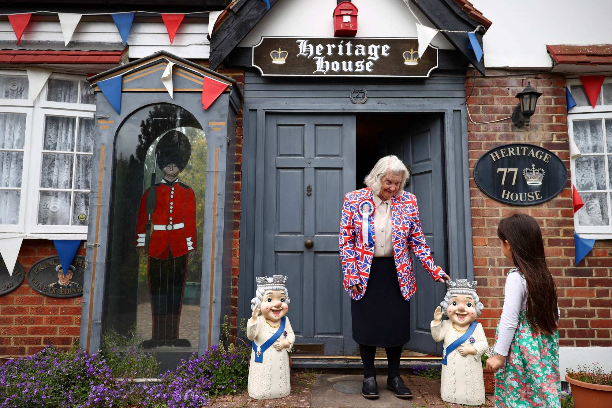 Tyler stands at her front door flanked by statues of Queen Elizabeth. Photo: AFP