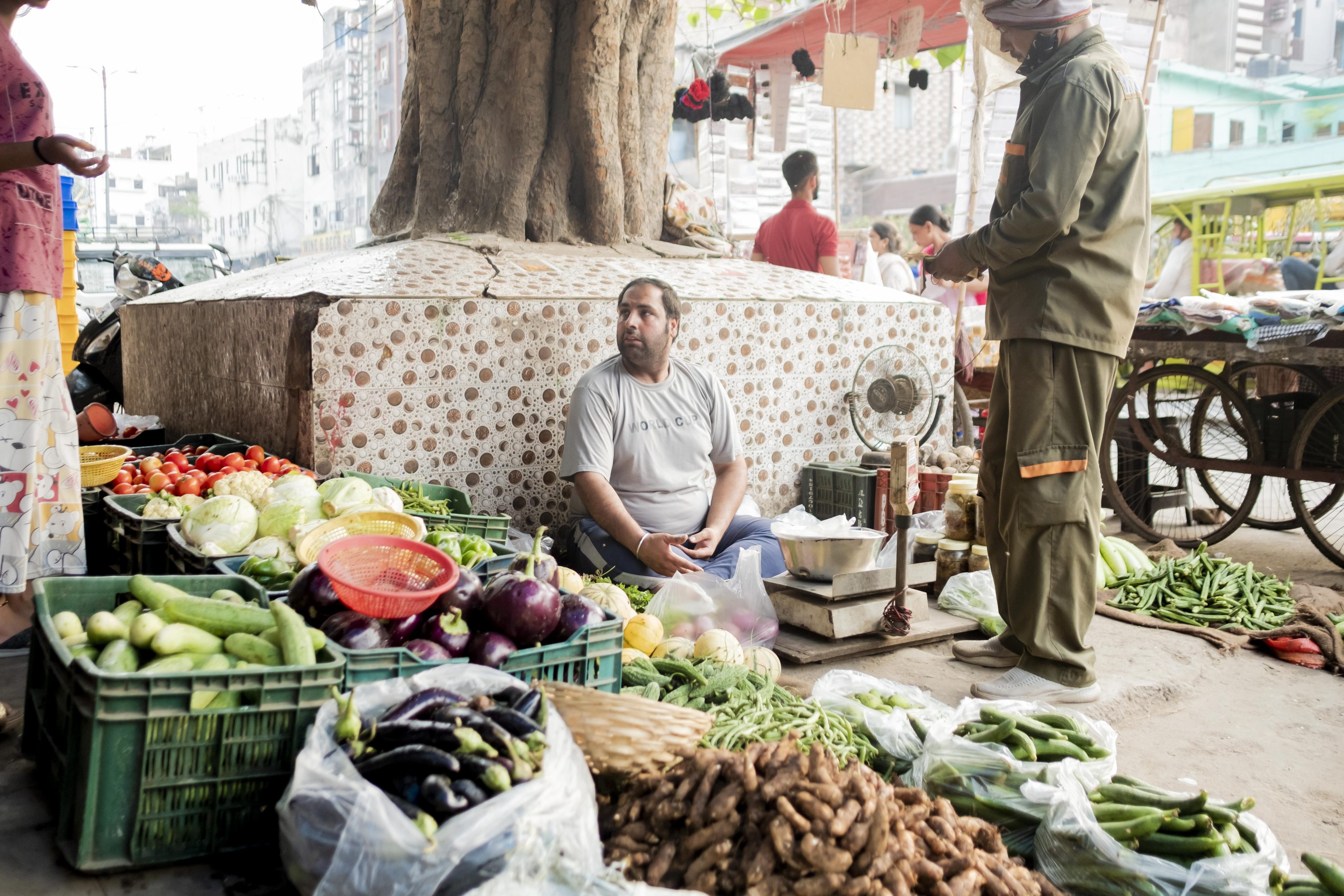 A vendor at a vegetable stall in New Delhi, India. Photo: Bloomberg