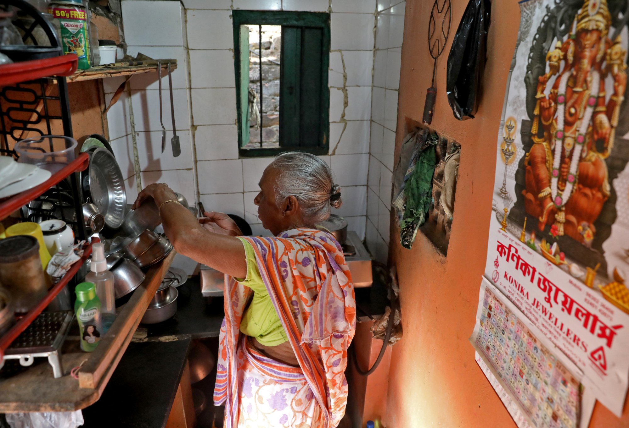 Indian widow Gita Sen, 70, who gets a small allowance from the government, prepares her morning tea inside her rented room in a Kolkata slum last month. Photo: Reuters