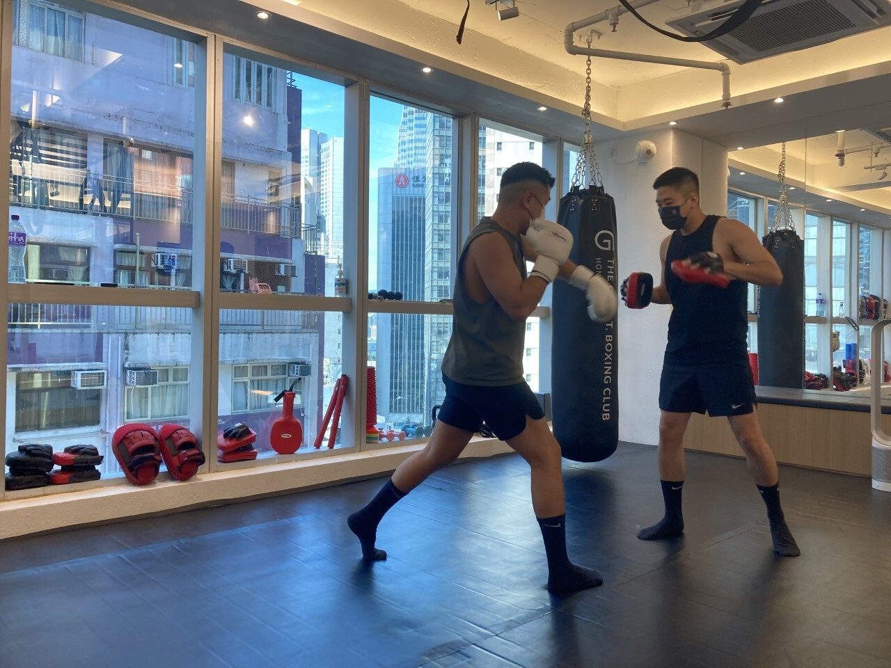 Leslie Wong (left) warms up with Sunny Ip before their afternoon session begins at G.O.A.T Boxing Club in Central. Photo: Kim Bo-eun