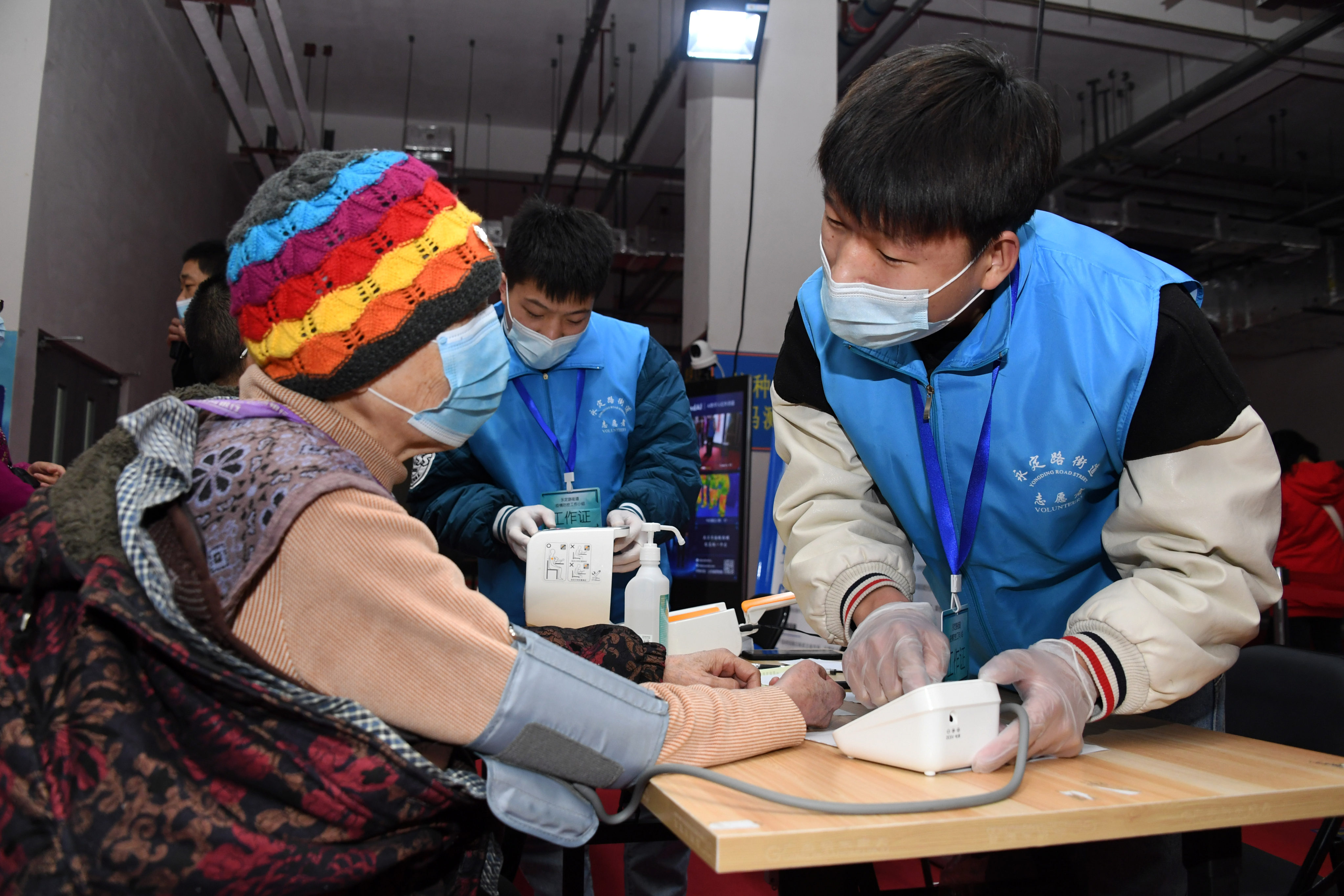 A resident of Beijing has her blood pressure taken before receiving a Covid-19 vaccine in March. Photo: Xinhua