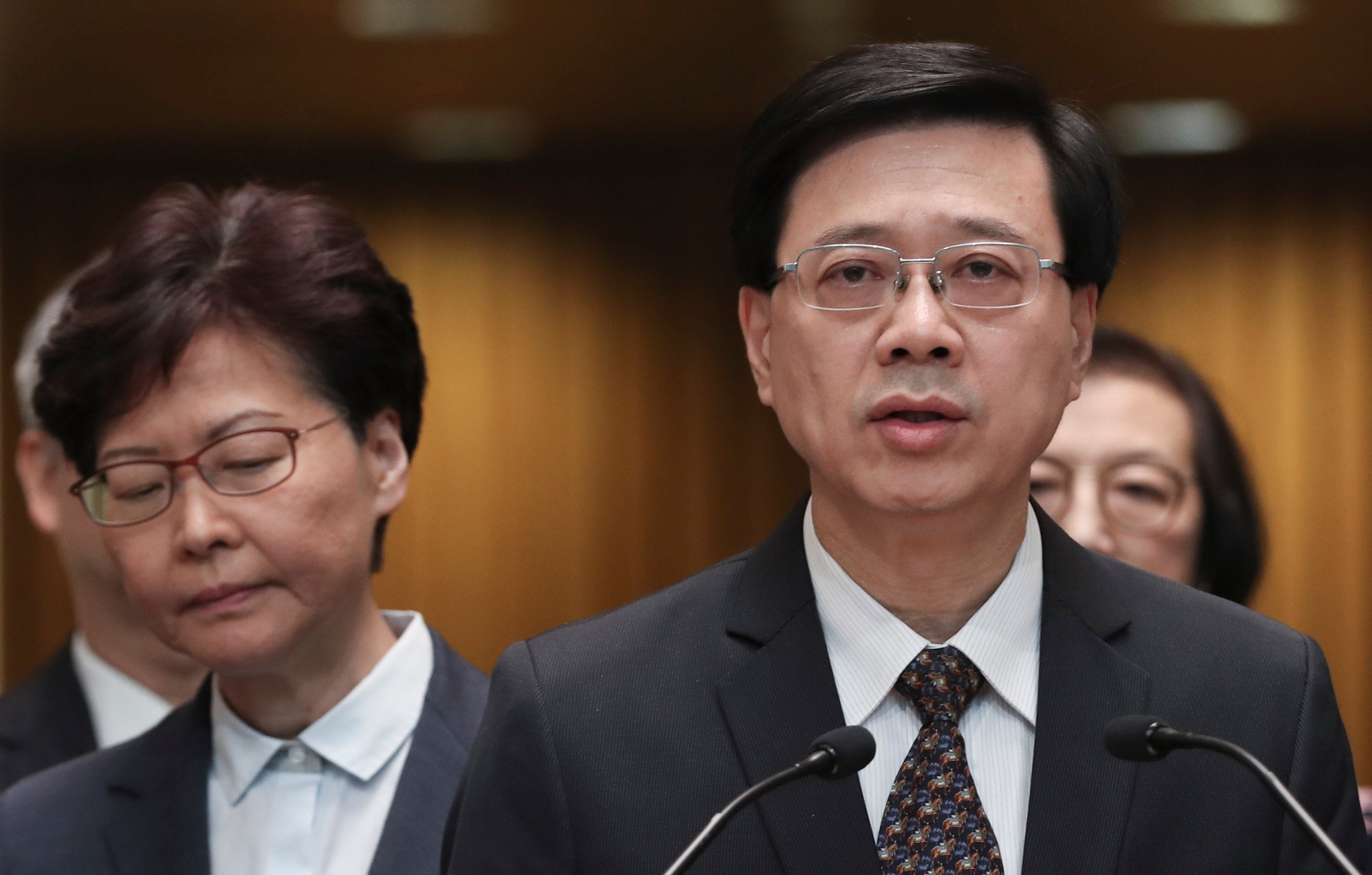 Chief Executive Carrie Lam listens as then secretary for security John Lee speaks to the media at the Chief Executive’s Office in Tamar on July 21, 2019. Photo: Robert Ng