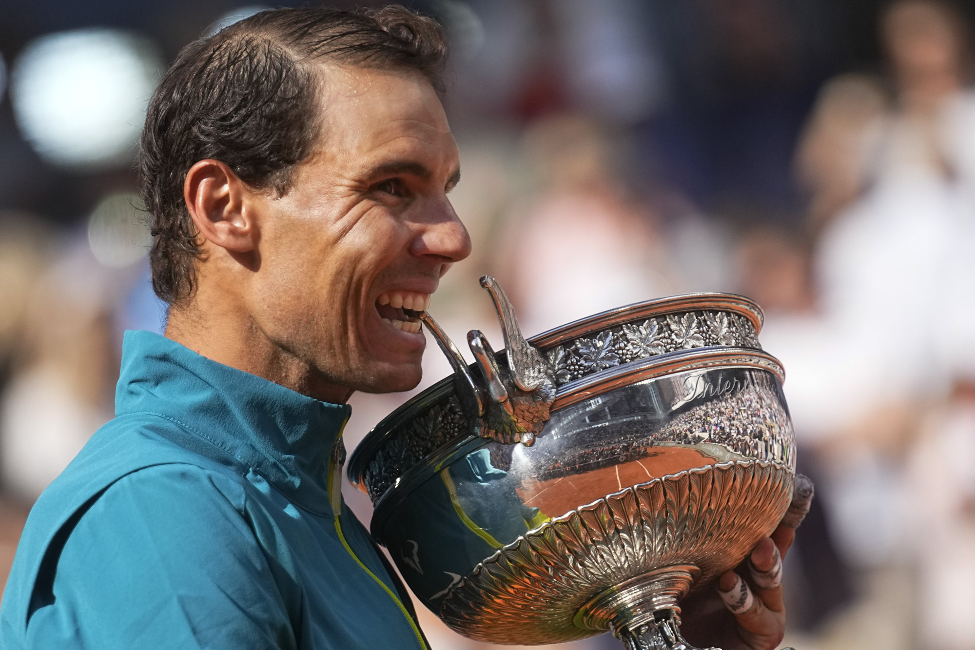Spain’s Rafael Nadal bites the trophy after winning the French Open tennis tournament at Roland Garros stadium in Paris, France on Sunday. Photo: AP