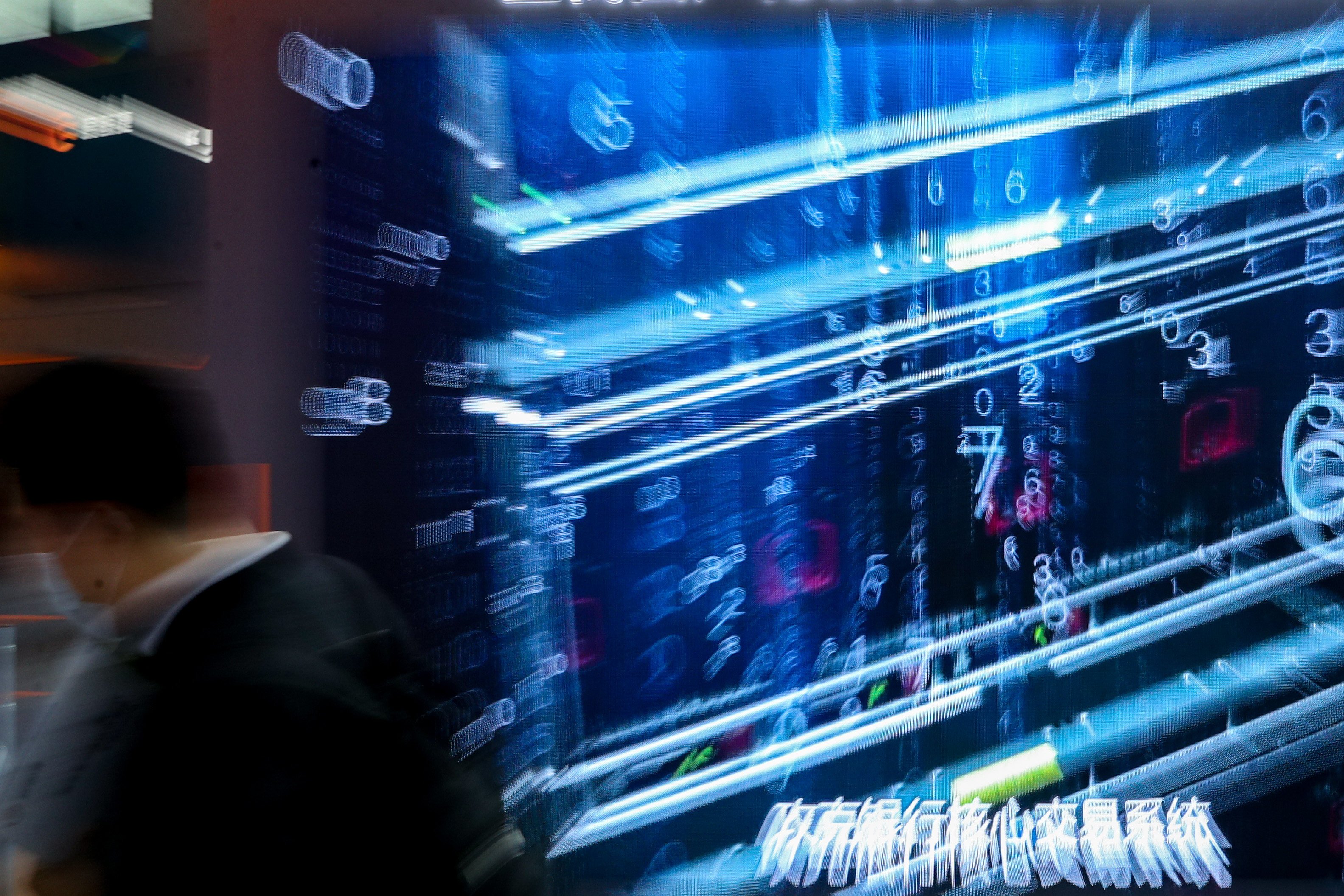 A visitor walks past a promotional video at the China International Big Data Industry Expo 2021 in Guiyang, Guizhou province on May 26, 2021. China passed two laws in September last year that restrict cross-border data flows and enforce localisation. Photo: Xinhua