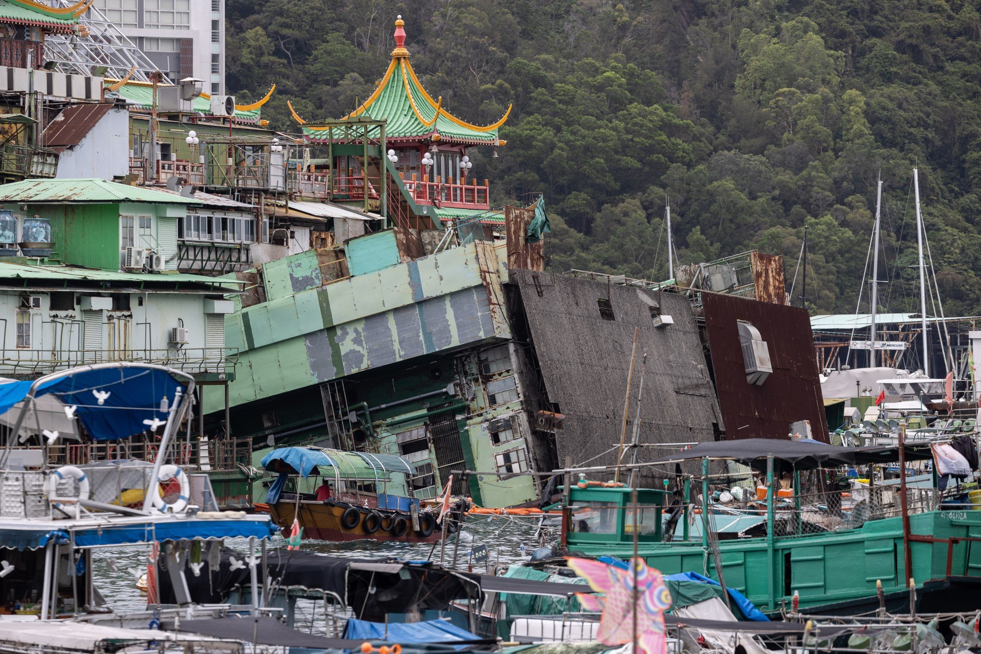 A 30-metre-long kitchen barge connected to the iconic Jumbo Floating Restaurant lies partially submerged after capsizing in Aberdeen, Hong Kong, on June 1. Photo: EPA-EFE