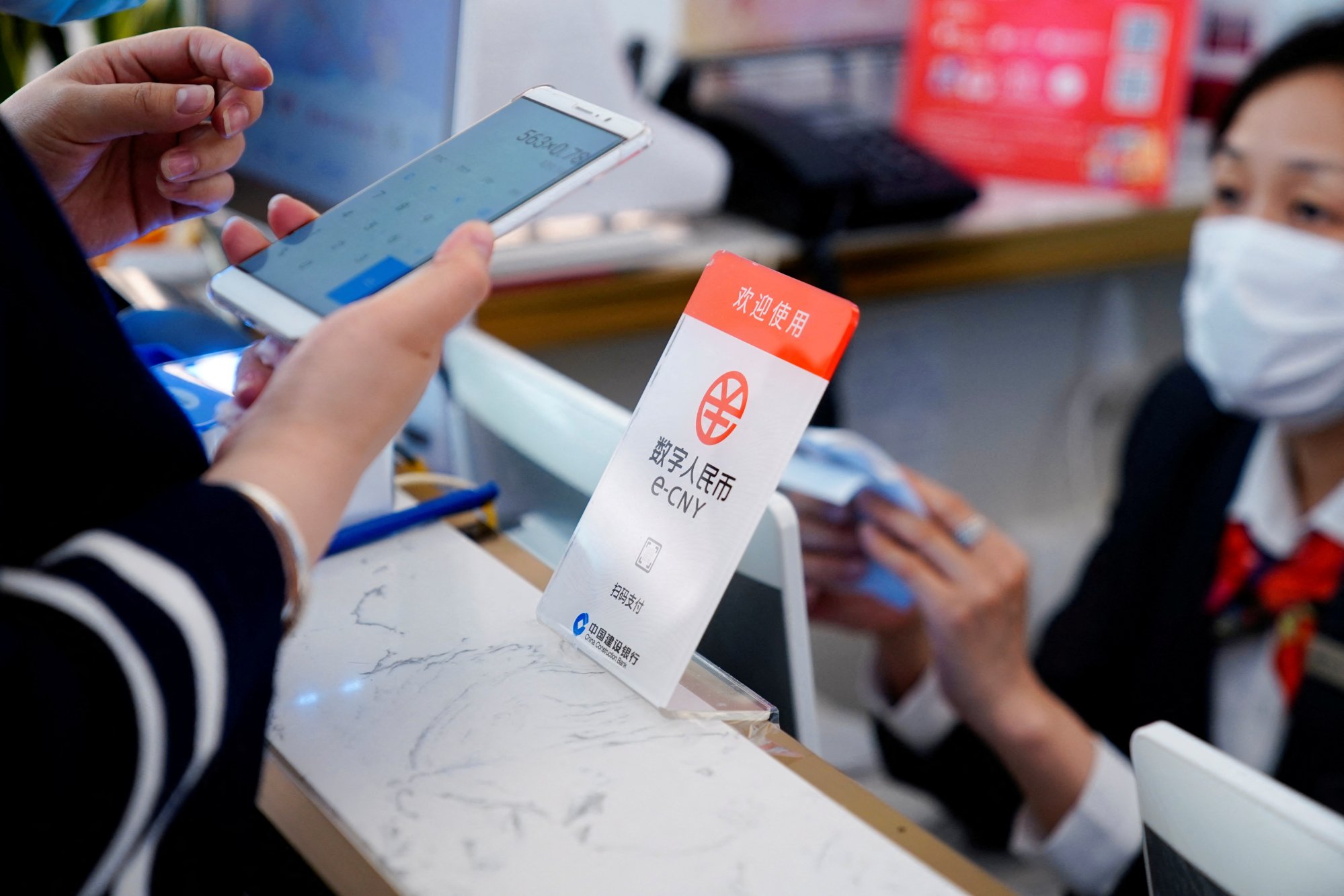 A sign for digital yuan, or e-CNY, is shown at a shopping centre in Shanghai on May 5. Photo: Reuters