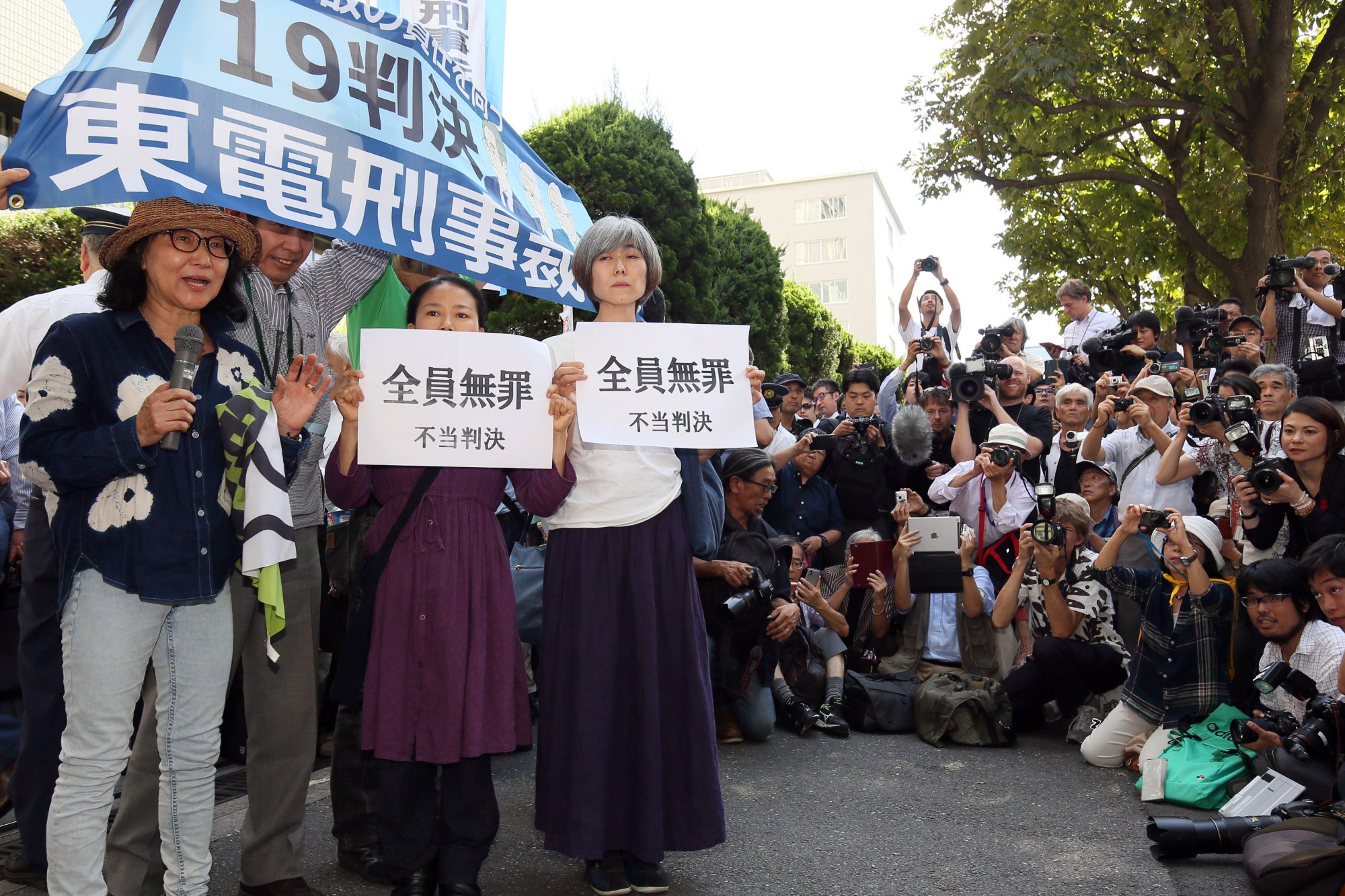Activists hold placards reading ‘All not guilty’ before the Tokyo District Court in September 2019. Three former executives of Tokyo Electric Power Company Holdings Inc. (TEPCO) were cleared on charges of negligence to prevent the March 2011 Fukushima nuclear disaster. Photo EPA-EFE/Jiji Press