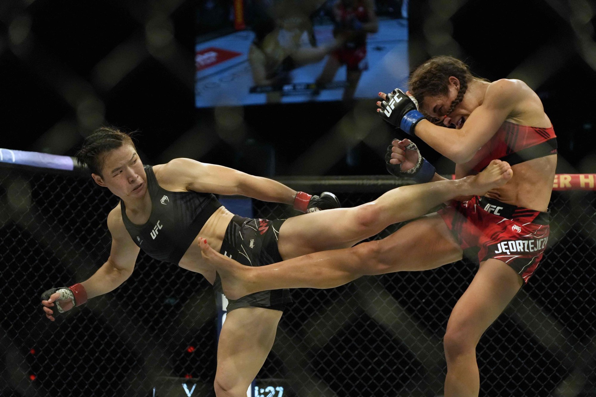 Zhang Weili lands a kick to the body against Joanna Jedrzejczyk at UFC 275 in Singapore. Photo: AFP