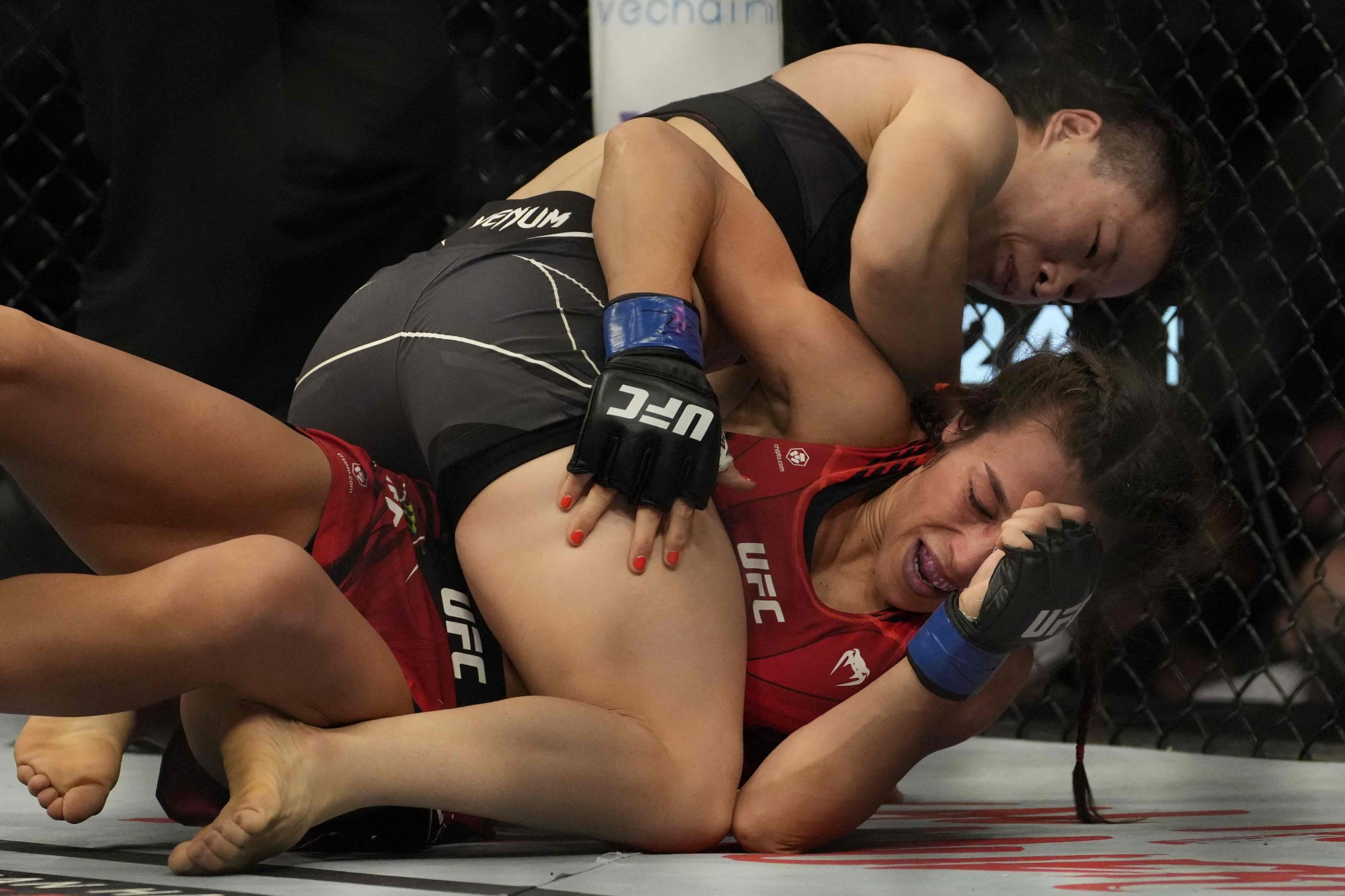 Zhang Weili controls Joanna Jedrzejczyk on the ground at UFC 275. Photo: AFP