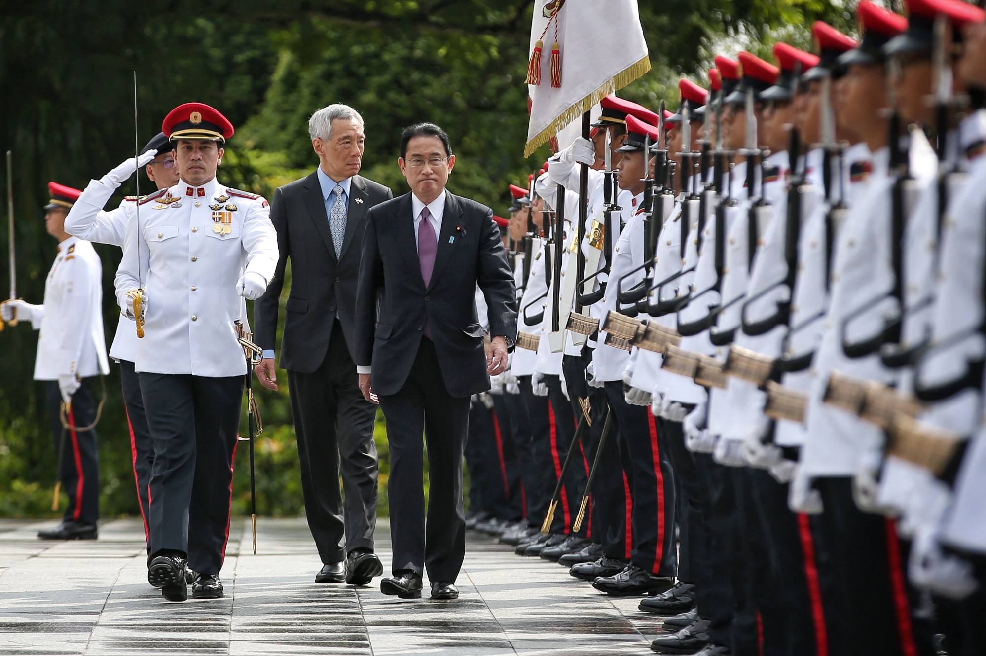 Japan’s Prime Minister Fumio Kishida (centre R) inspecting a Singapore guard of honour with Singapore’s Prime Minister Lee Hsien Loong. Kishida delivered a keynote address at the Shangri-La Dialogue on Friday. Photo: AFP