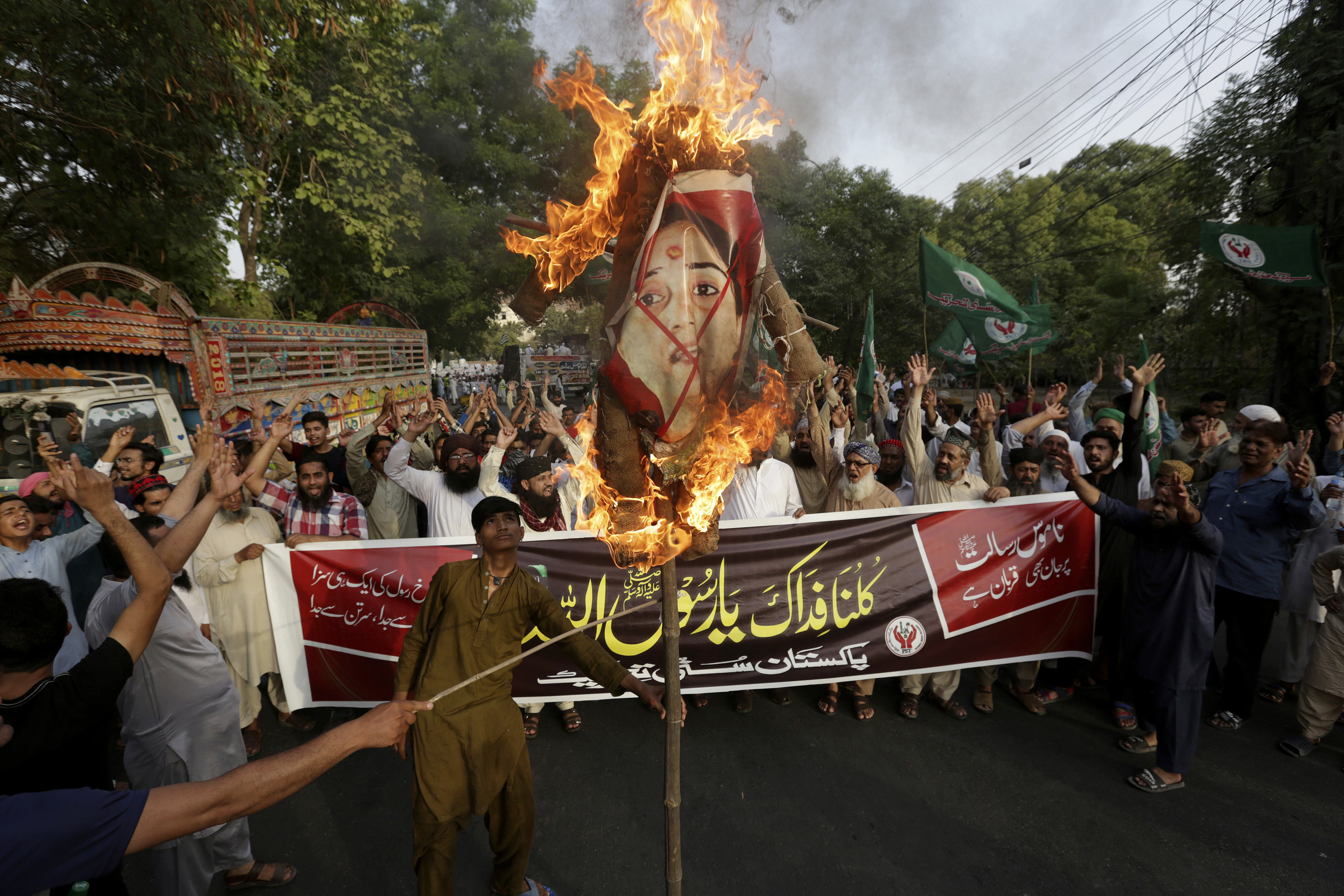 Supporters of a religious group in Pakistan burn a picture of BJP’s Nupur Sharma. Photo: AP
