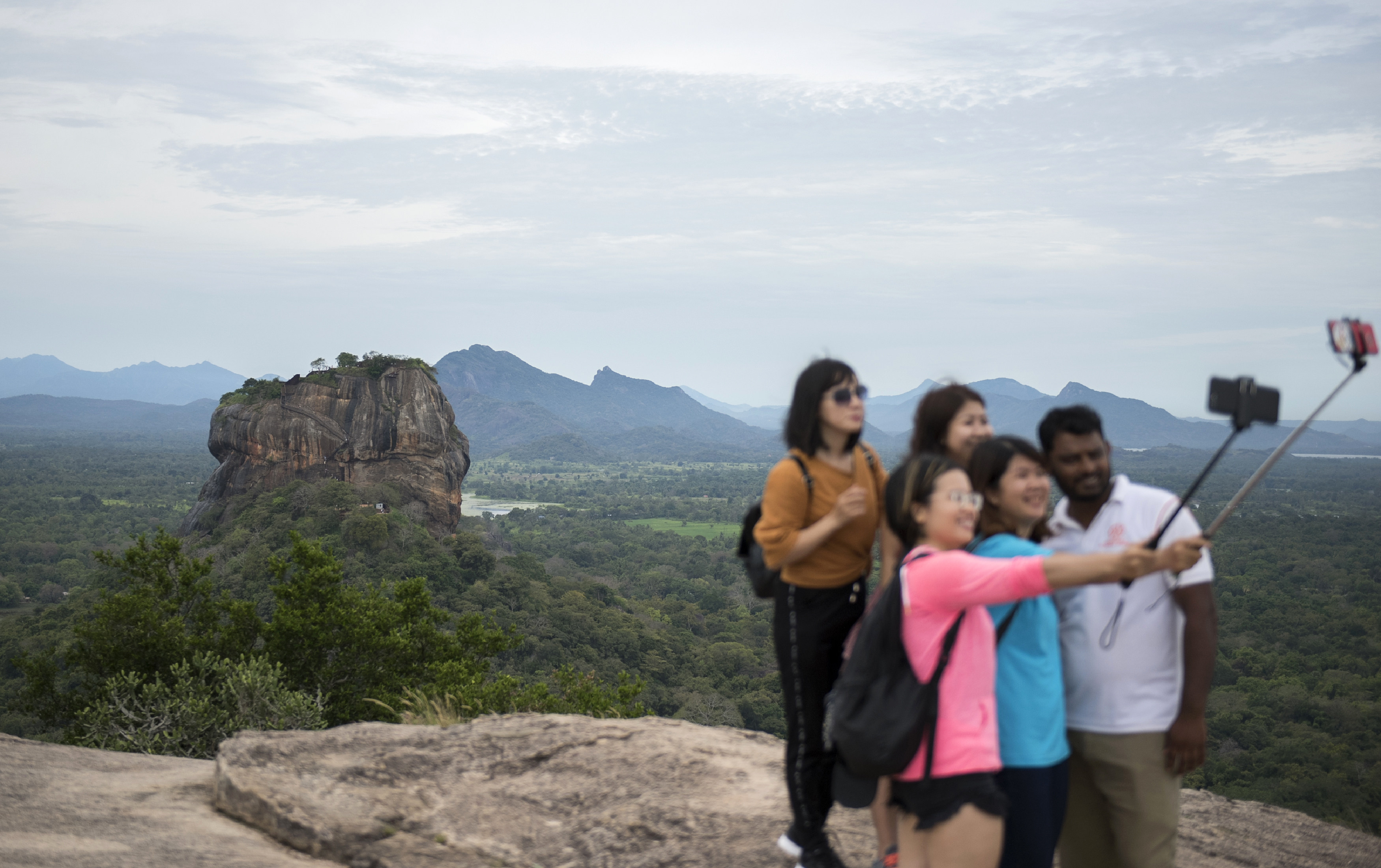 A group of tourists take a selfie in Sigiriya, Sri Lanka. Photo: AFP
