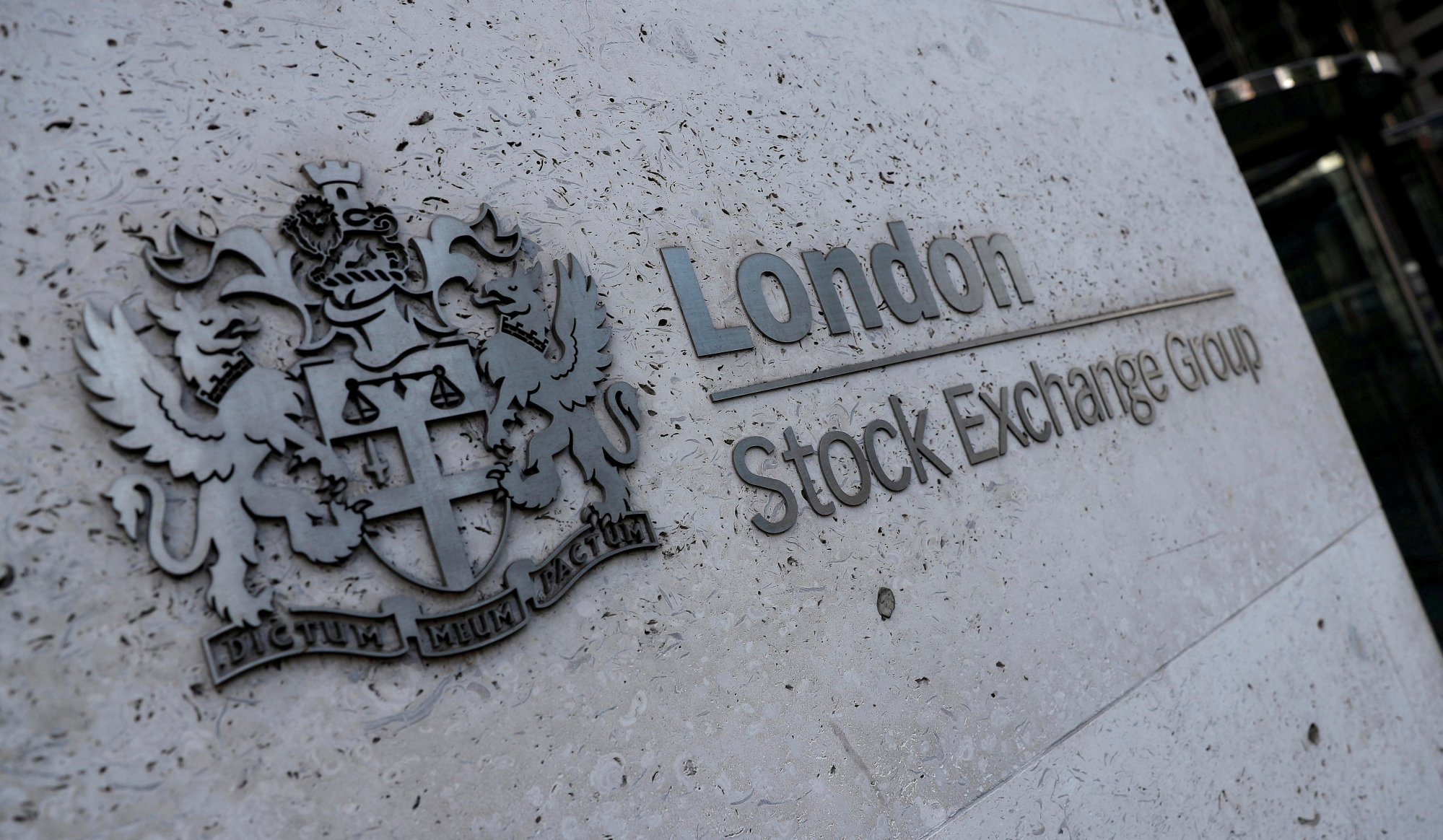 Signage is seen outside the entrance of the London Stock Exchange. Photo: Reuters