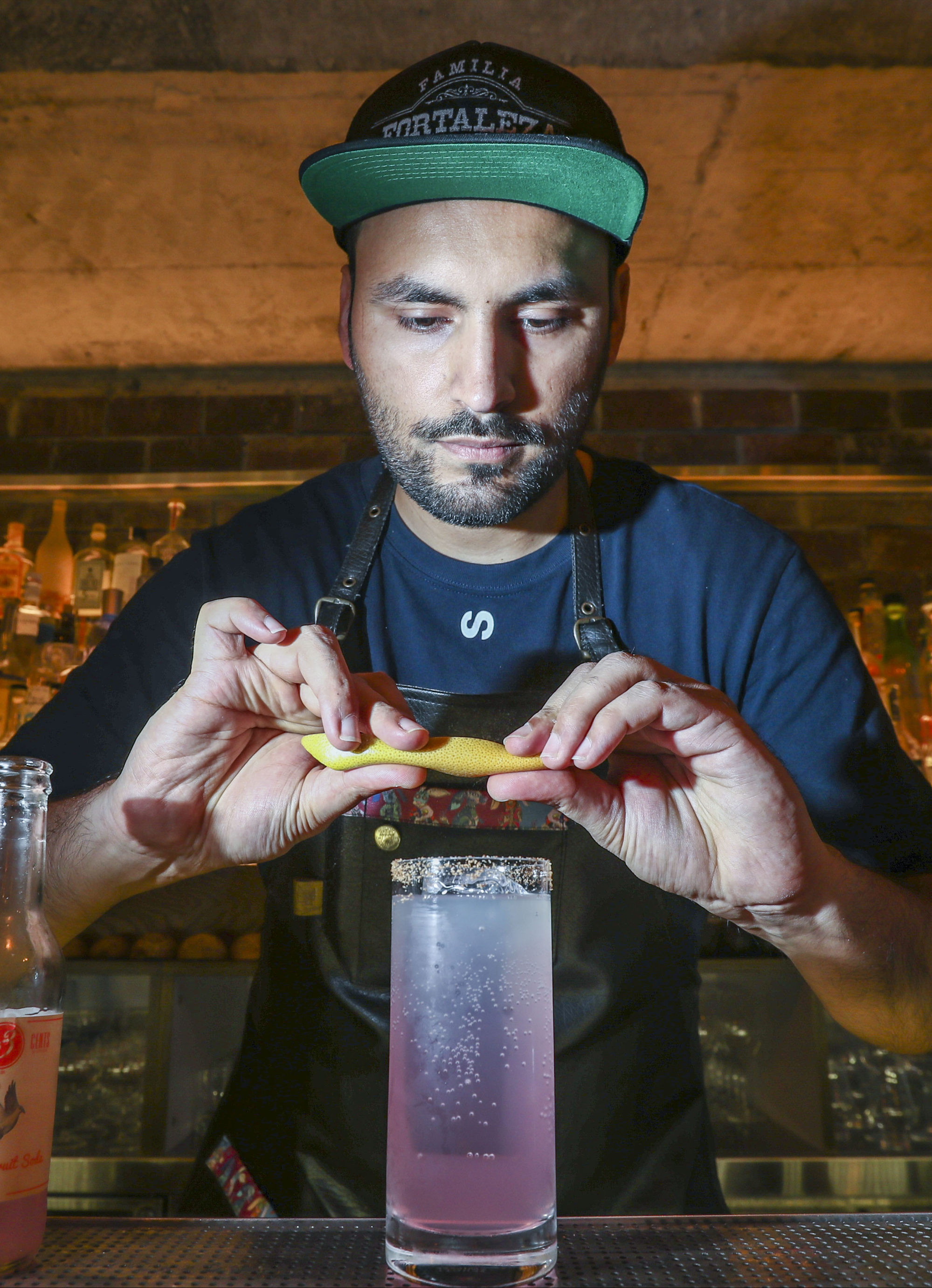 Coa co-founder Jay Khan mixes an Oaxacan Paloma cocktail at the bar. Photo: Nora Tam