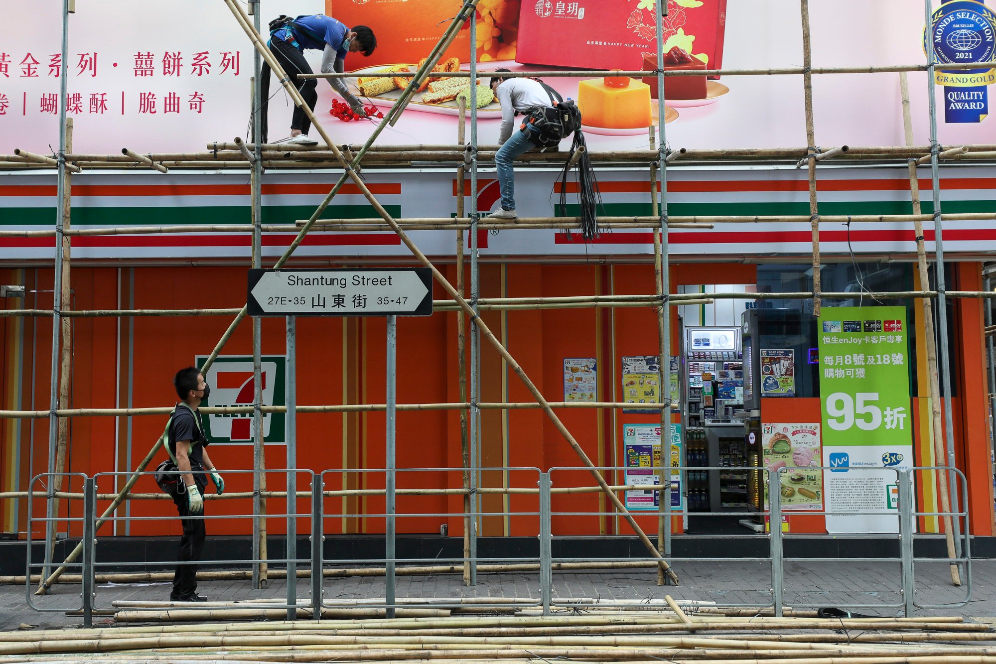 Men work on bamboo scaffolding in Mong Kok on May 23. Employers must ensure the working environment is free from occupational hazards. Photo: Xiaomei Chen