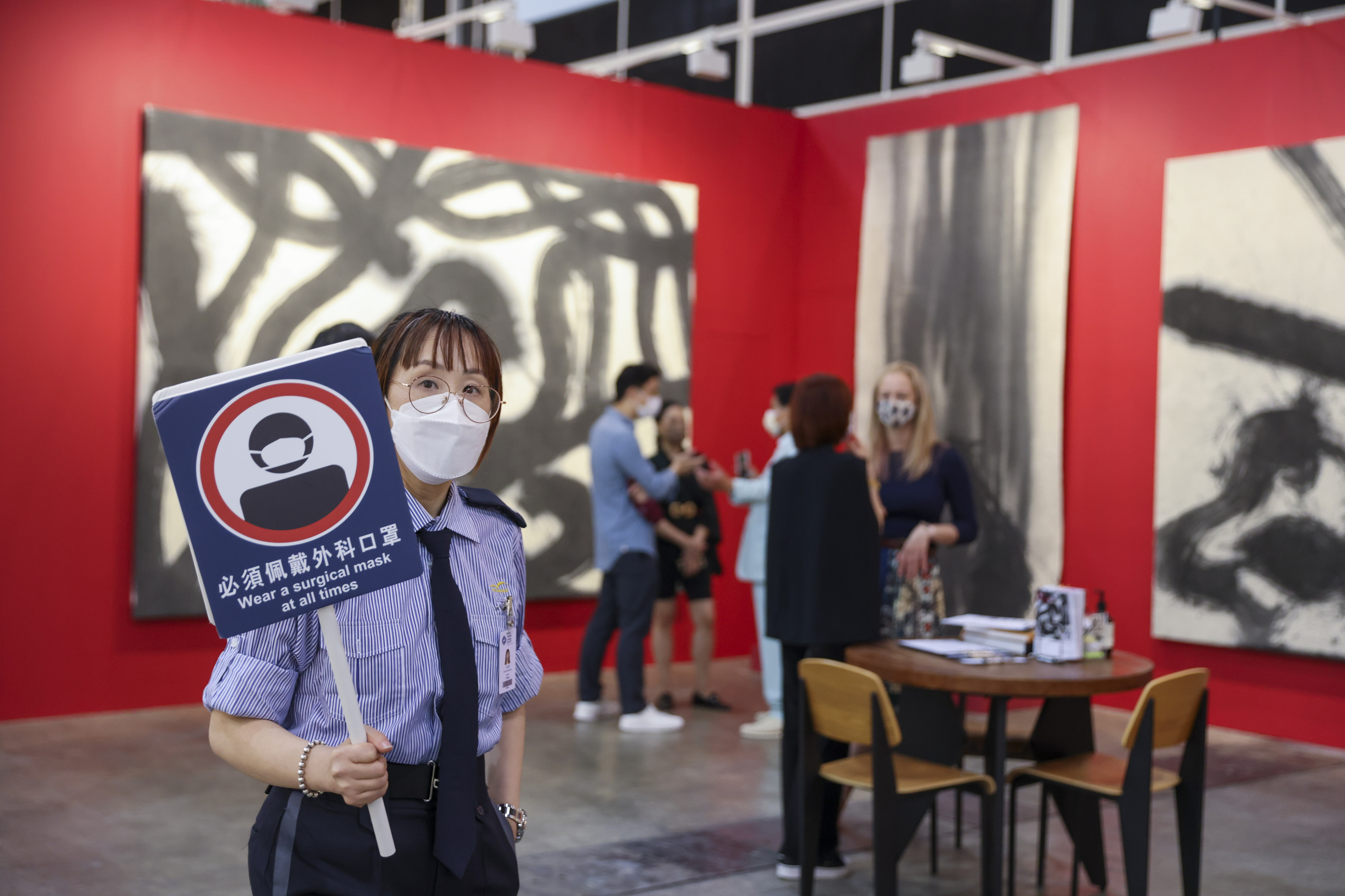 A security guard reminds visitors to wear face masks at all times in the Leo Gallery during a private viewing of Art Basel Hong Kong, held at the Hong Kong Convention and Exhibition Centre in Wan Chai on May 25. Photo: Nora Tam