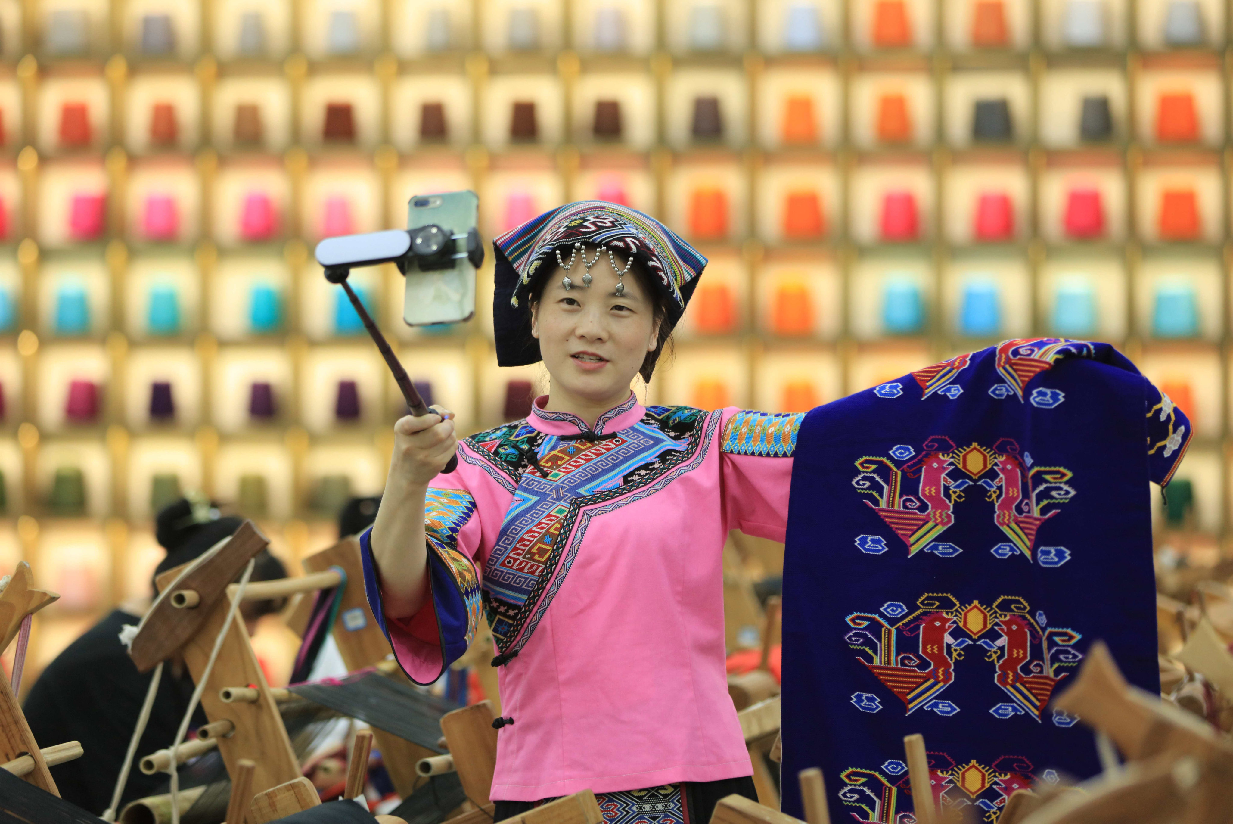 A woman promotes traditional tapestry weaving in a live stream. Tencent is betting big on live-streaming e-commerce through WeChat Channels, a video platform. Photo: Xinhua