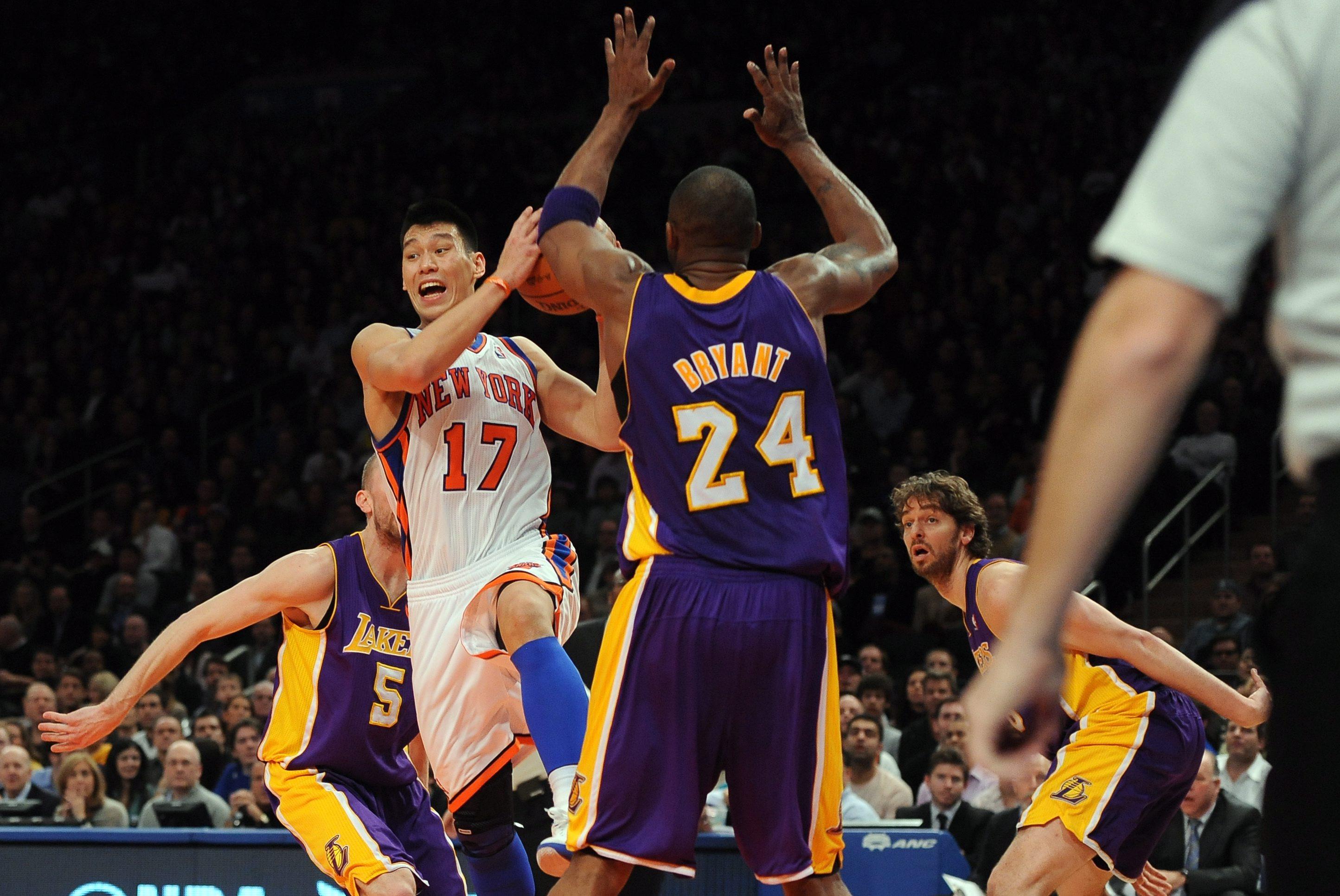 Former New York Knicks point guard Jeremy Lin  drives to the basket as Los Angeles Lakers shooting guard Kobe Bryant defends at Madison Square Garden on February 10, 2012.  Photo: EPA