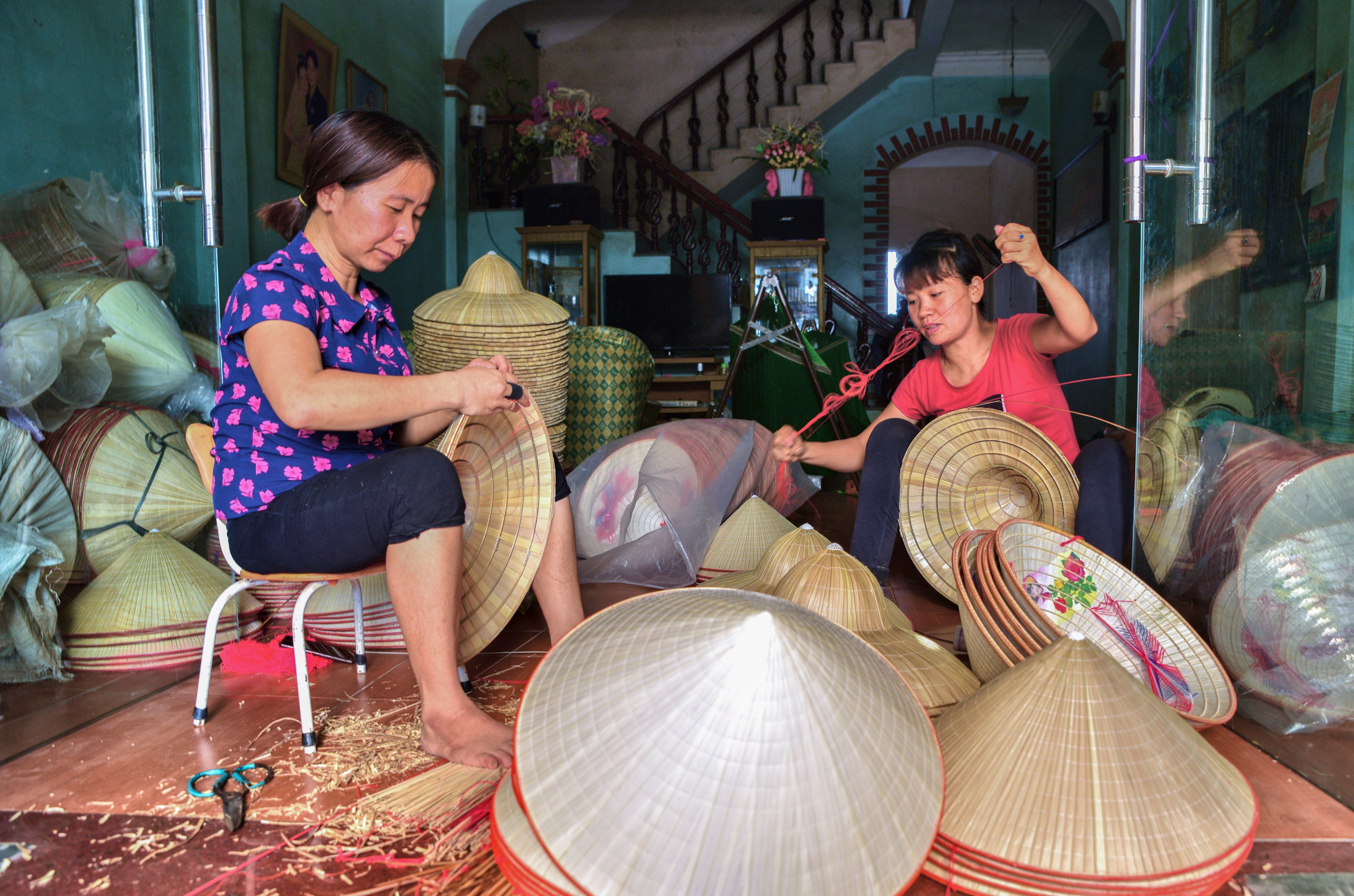 Artisans make conical hats in Chuong village, Hanoi, Vietnam. A dying trade because of cheaper factory-made hats, it could be revived by a new tourism strategy to promote the city’s craft villages. Photo: Ronan O’Connell